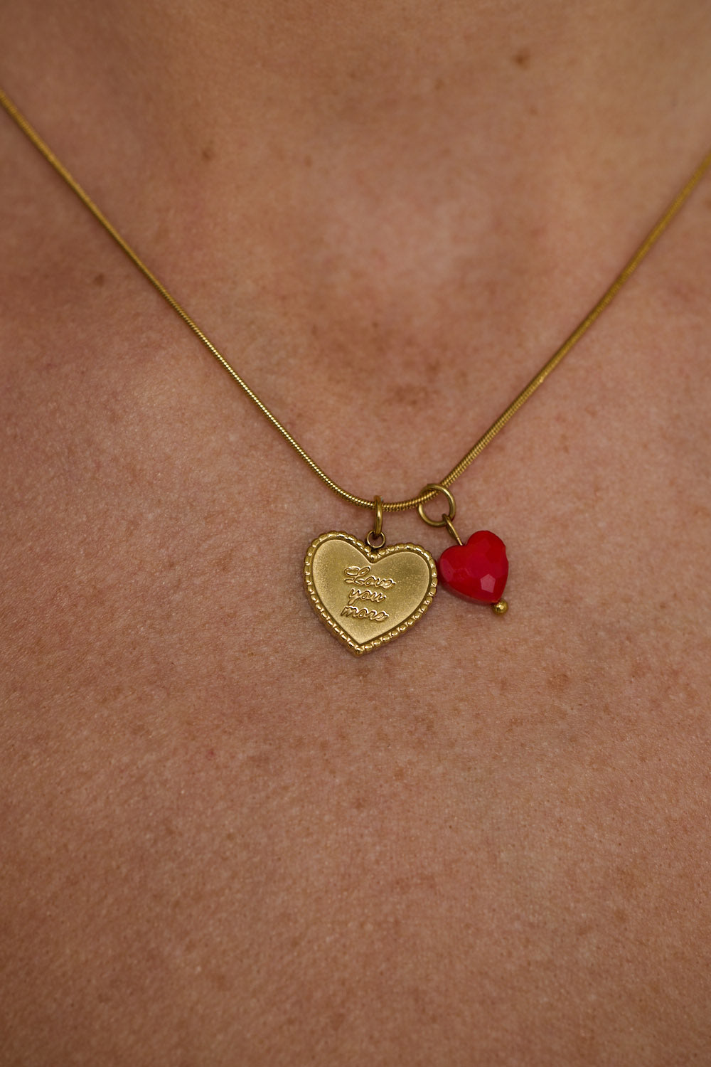 Love You More Necklace in gold with heart charm detailing, front display view on neutral background