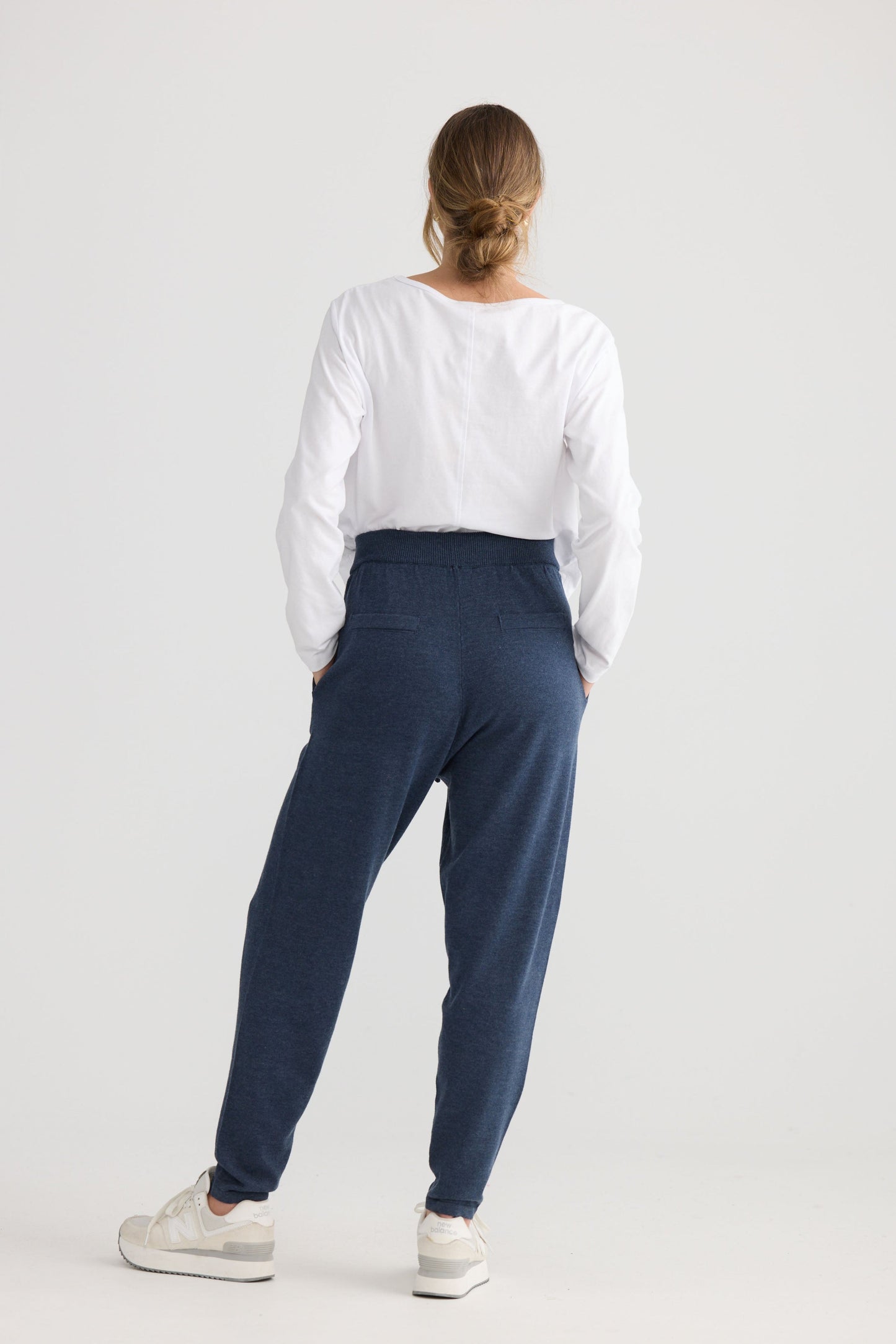 Model wearing Woodside Pant in navy, styled for everyday wear.