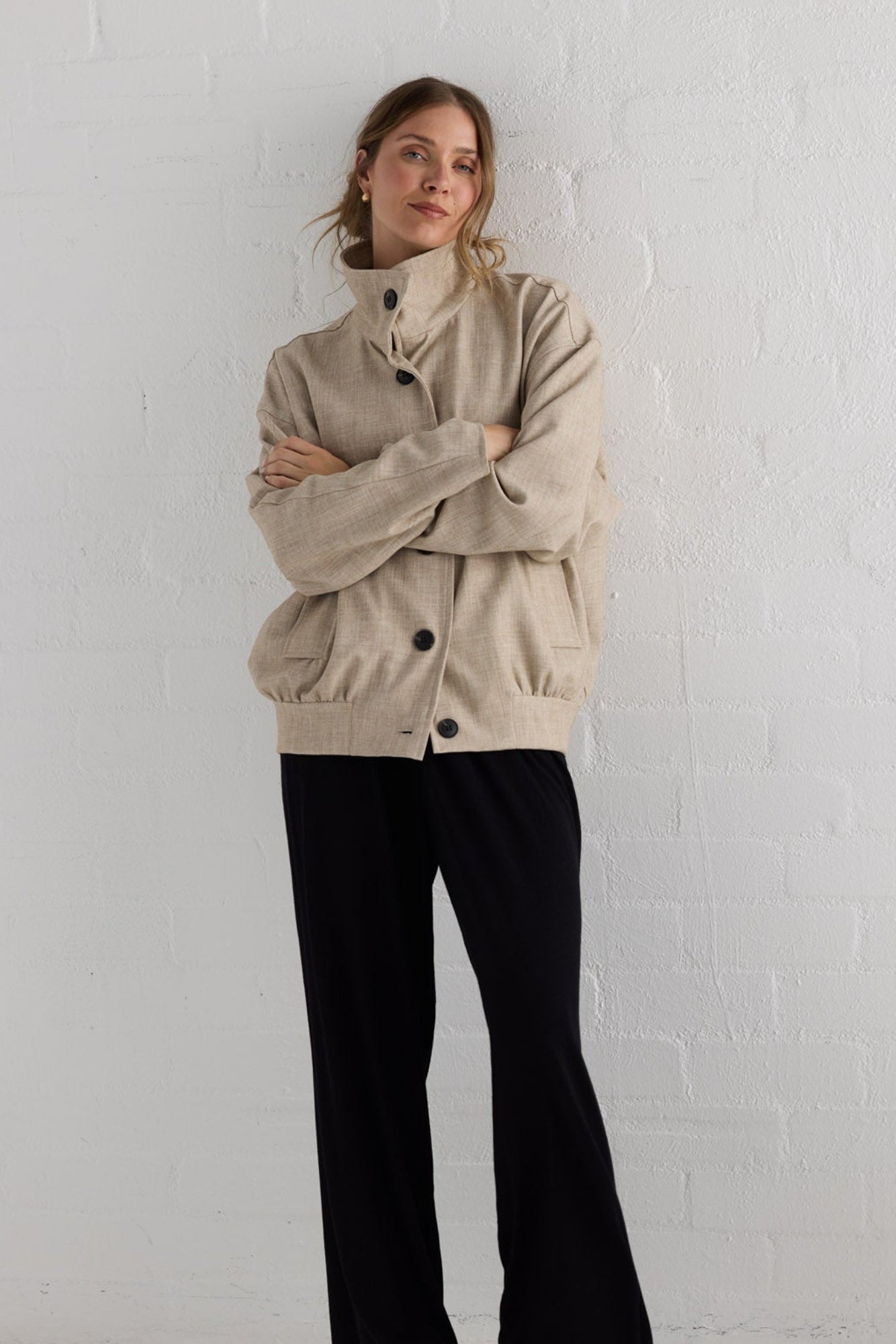 Campaign image of model wearing Edie Jacket in stone.