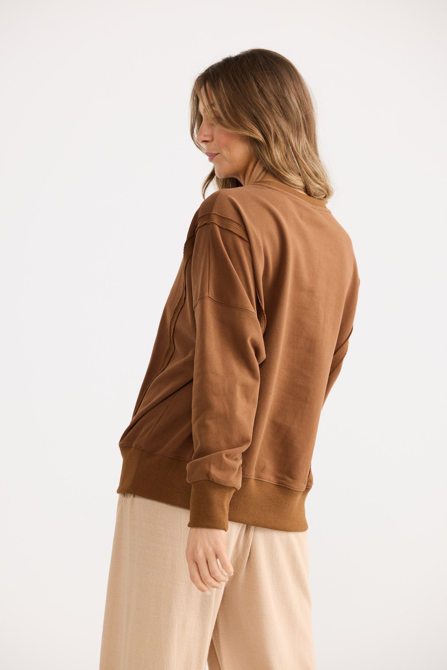 Woman wearing a brown jacket on a white background