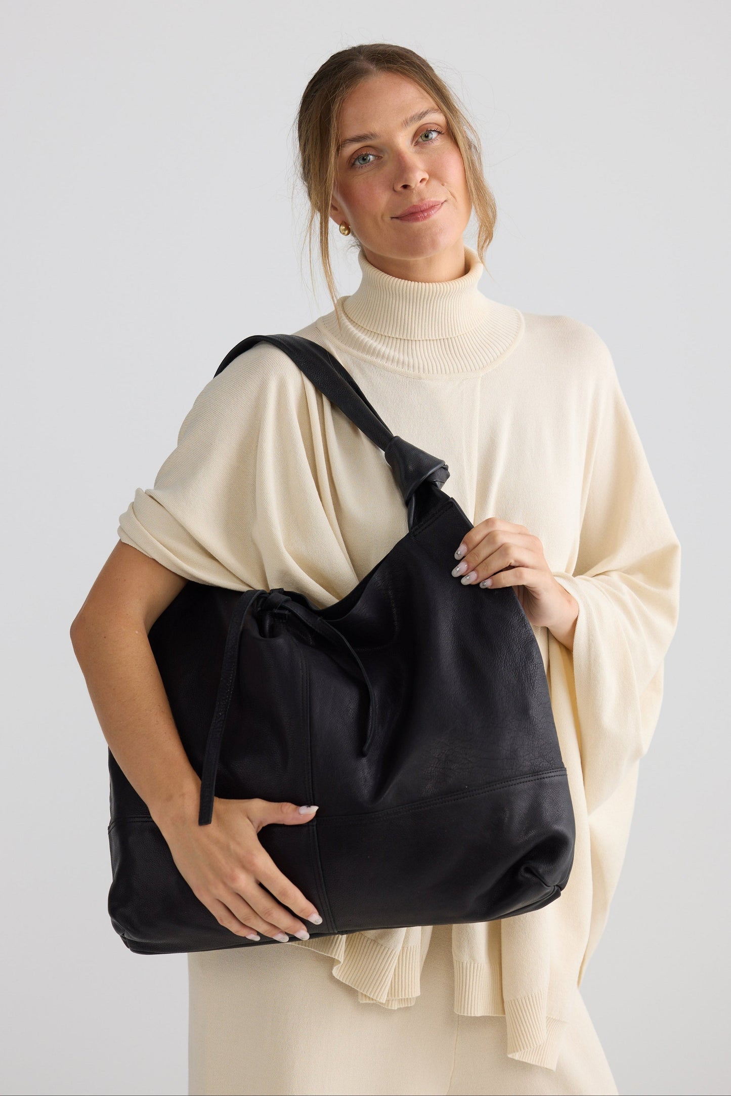 Lina Bag - Black bag in black with slouch silhouette, styled view on white background