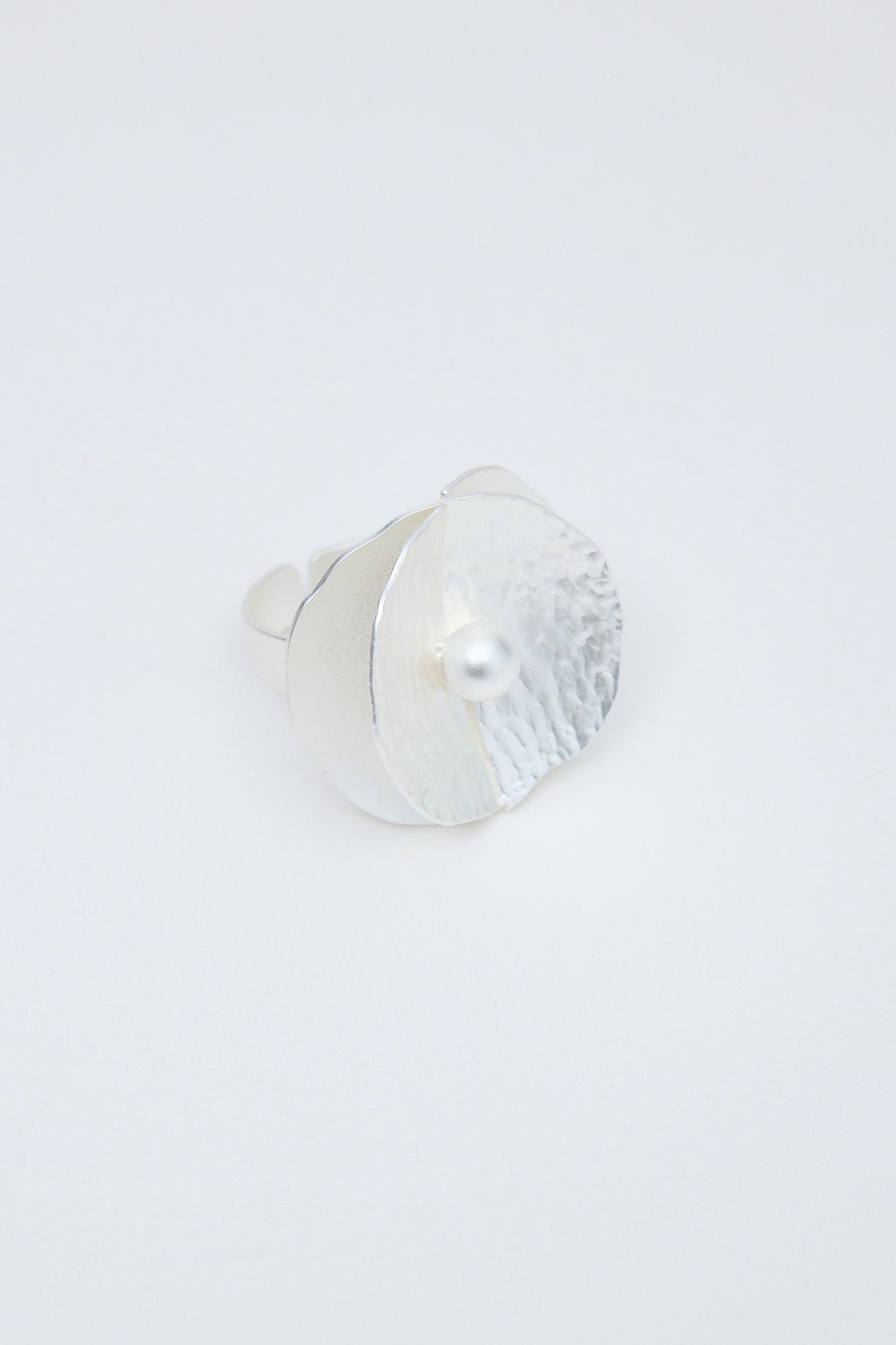 Silver ring on a light gray background