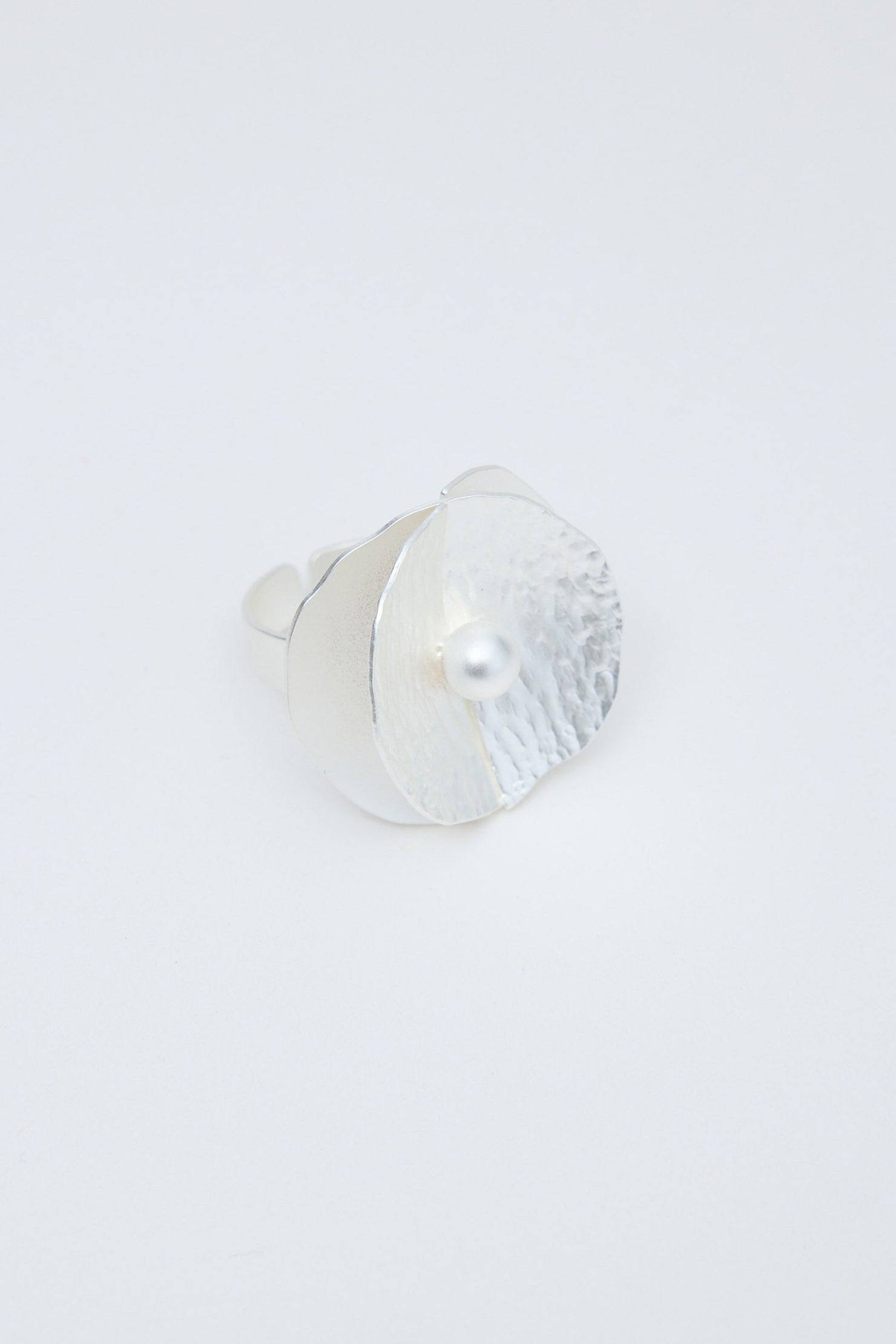 Silver ring on a light gray background