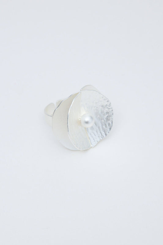 Silver ring on a light gray background