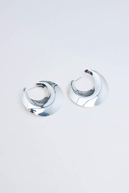 Pair of silver hoop earrings on a light gray background