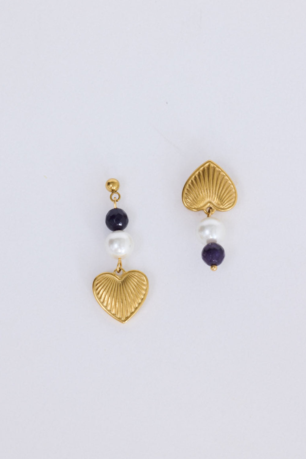 Janice Earrings in black with heart charm detail, angled view on white background