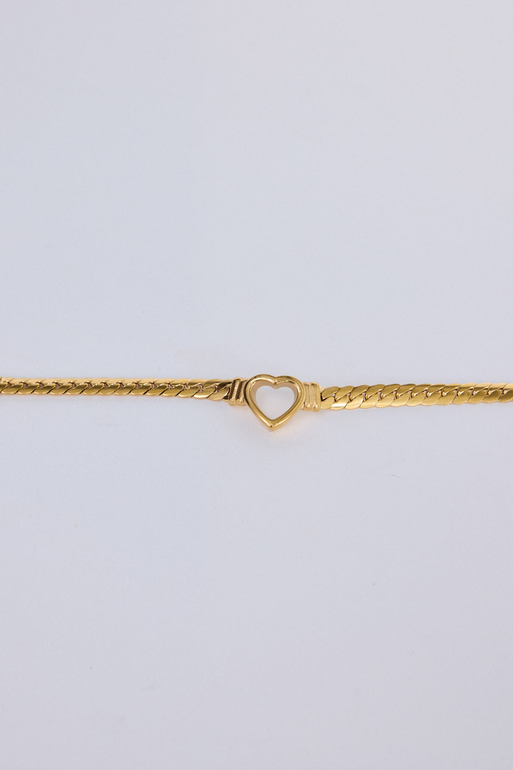 Hearts Bracelet in gold with delicate heart link detailing, flat lay detail view on white background