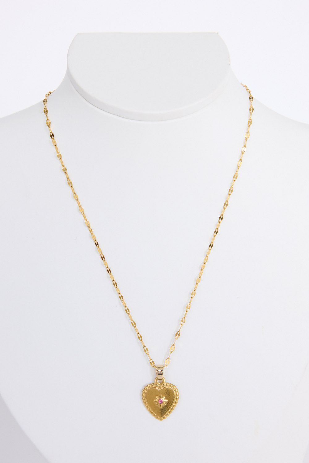 Aura Necklace in gold with heart pendant and stone detail, front view on white background