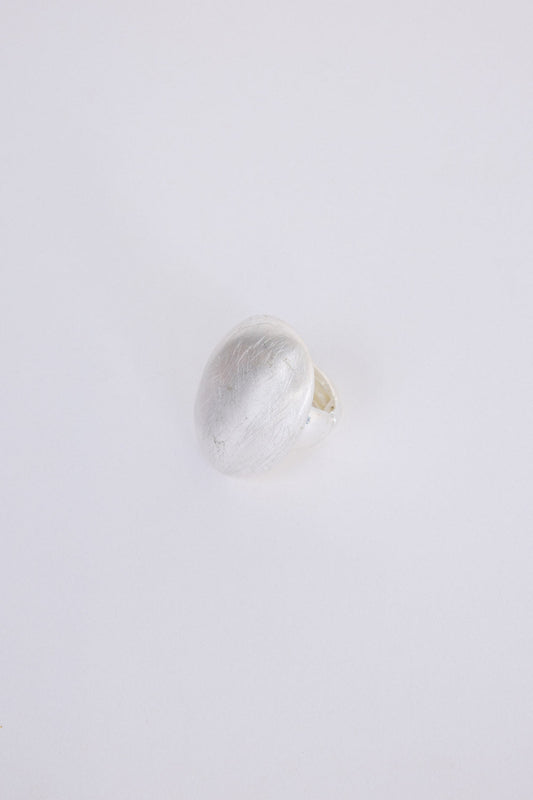 Nola Ring in silver with smooth domed face and brushed texture finish, front view on white background