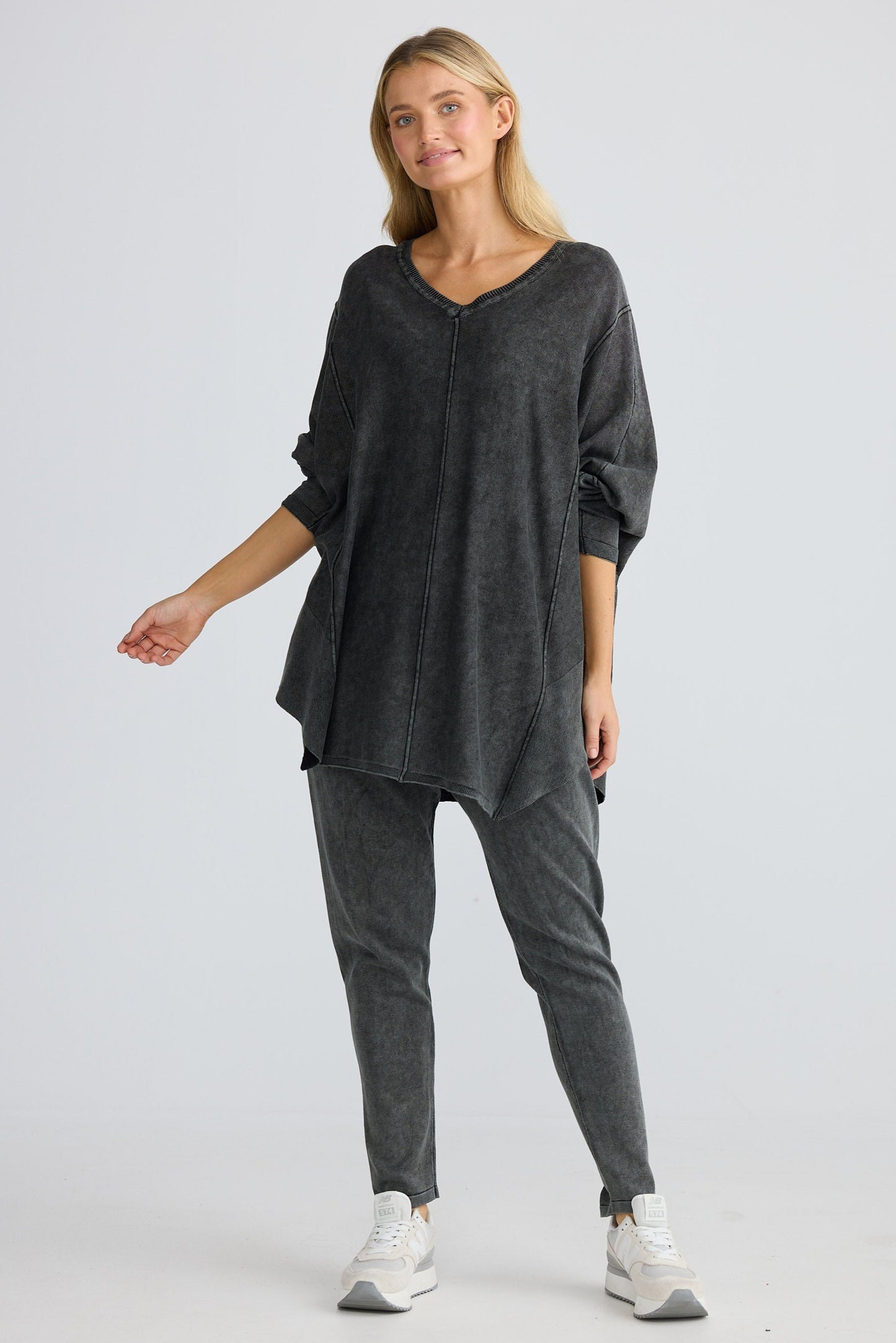 Woman wearing a dark gray outfit on a white background