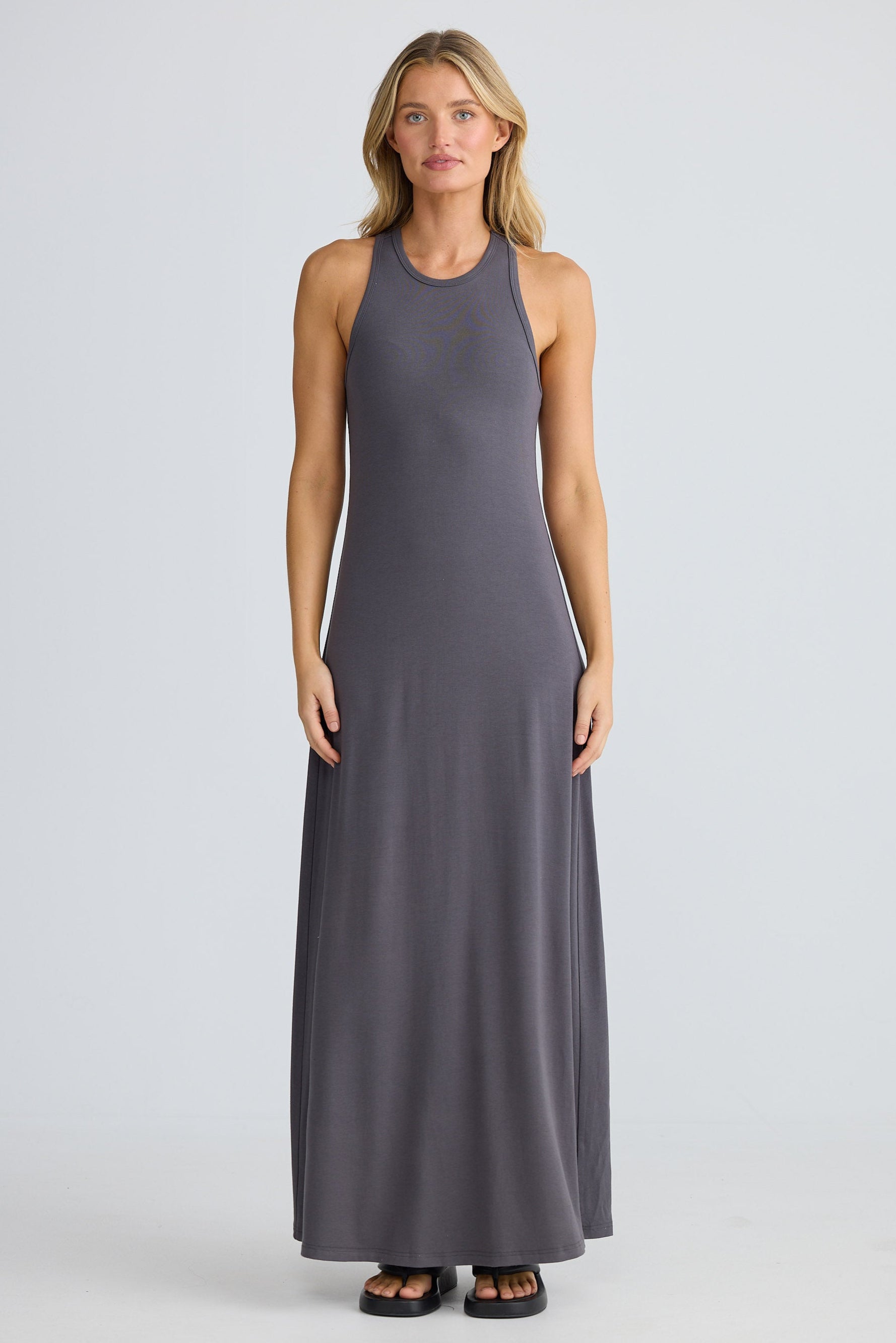 Woman wearing a long gray dress on a white background