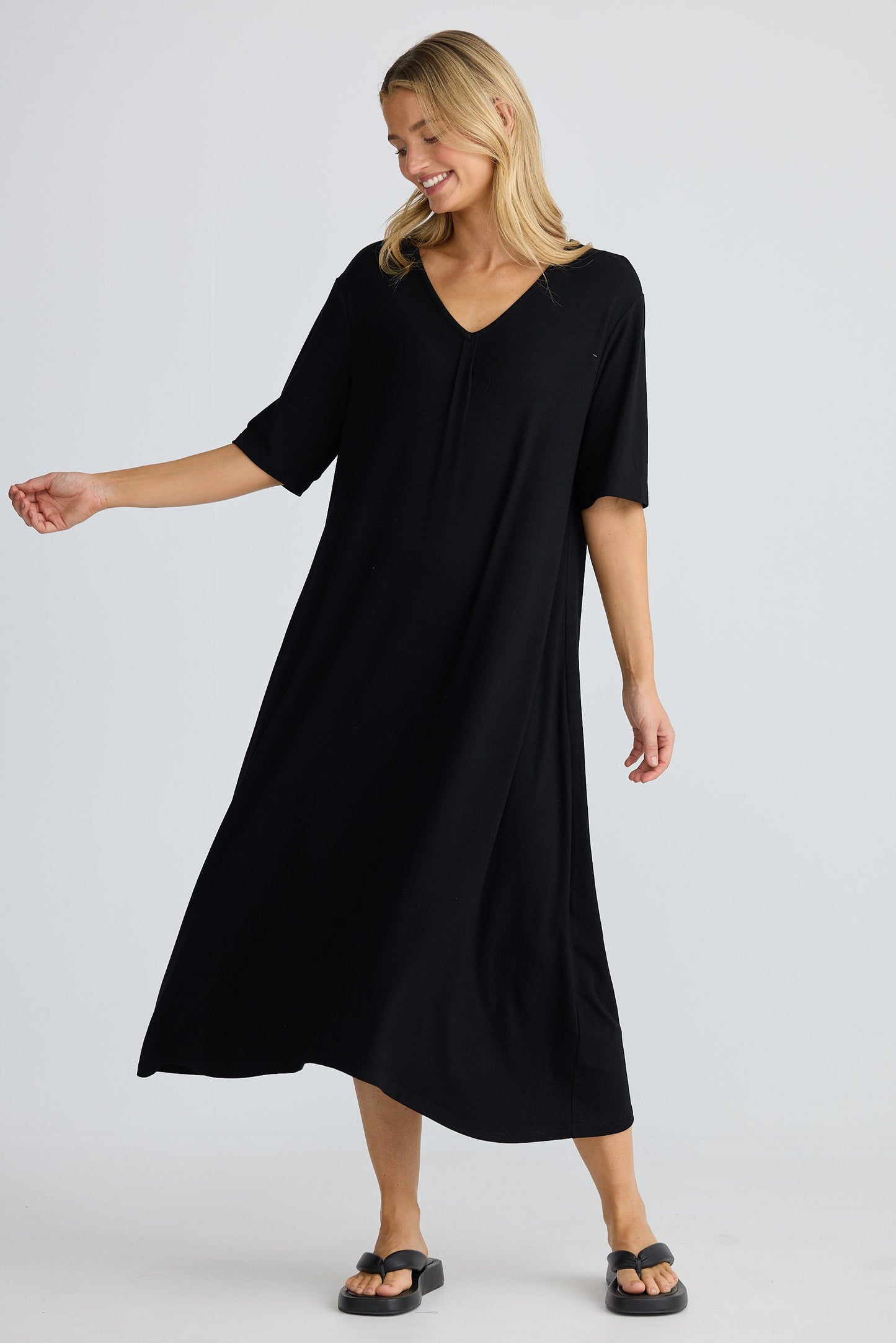 Woman wearing a black dress on a white background