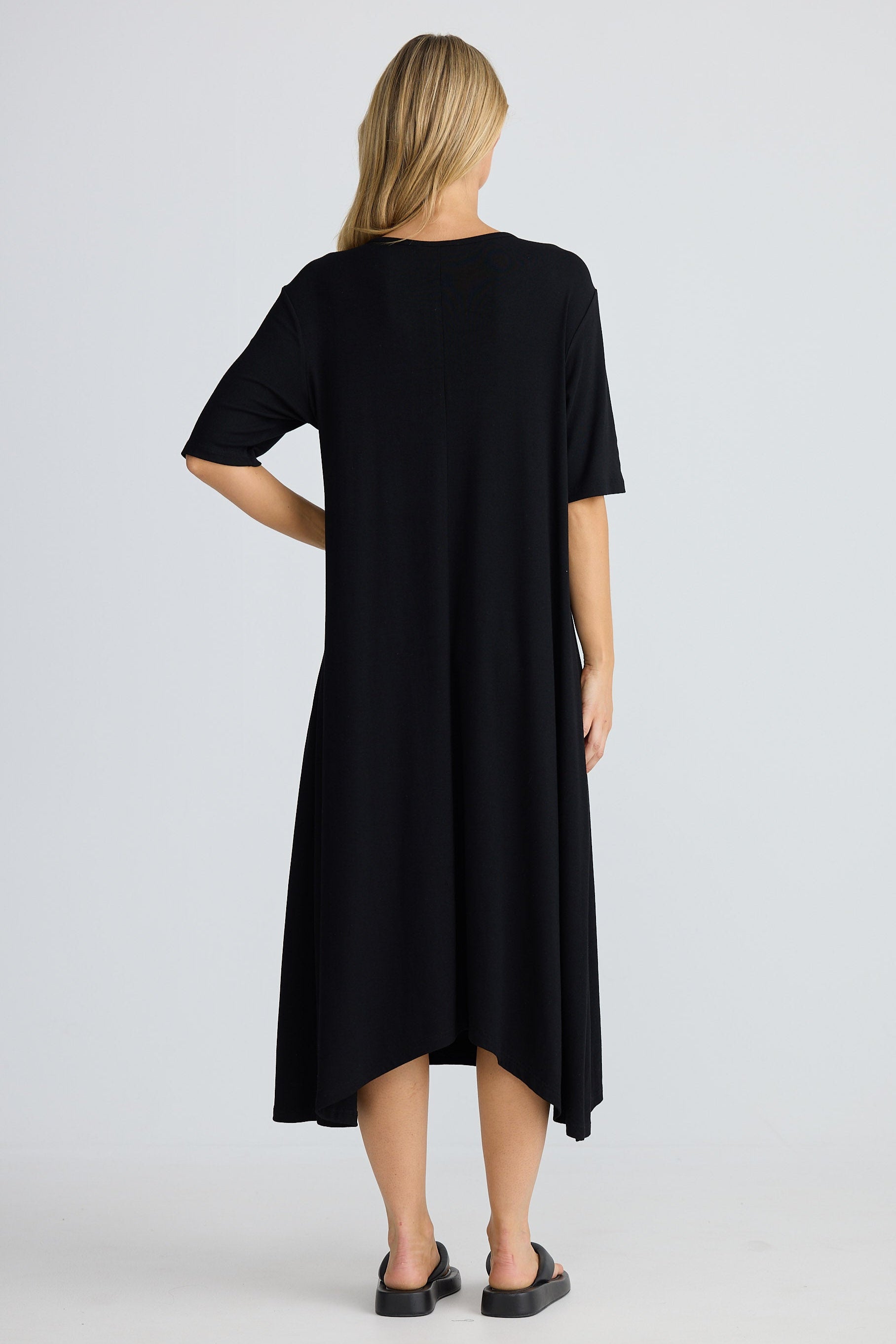 Black dress worn by a person on a white background