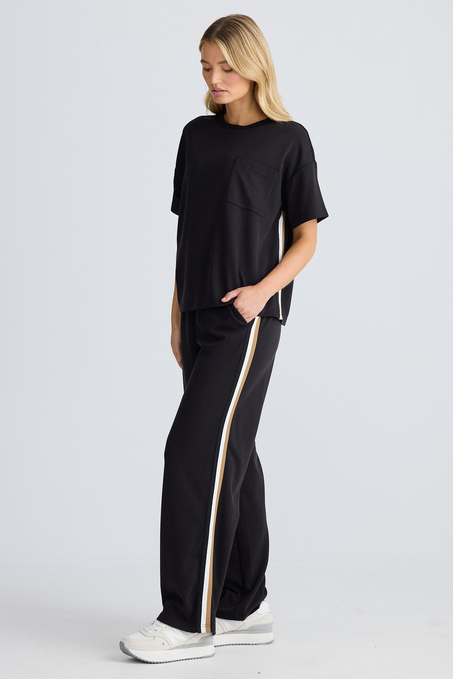 Person wearing a black outfit with a white background