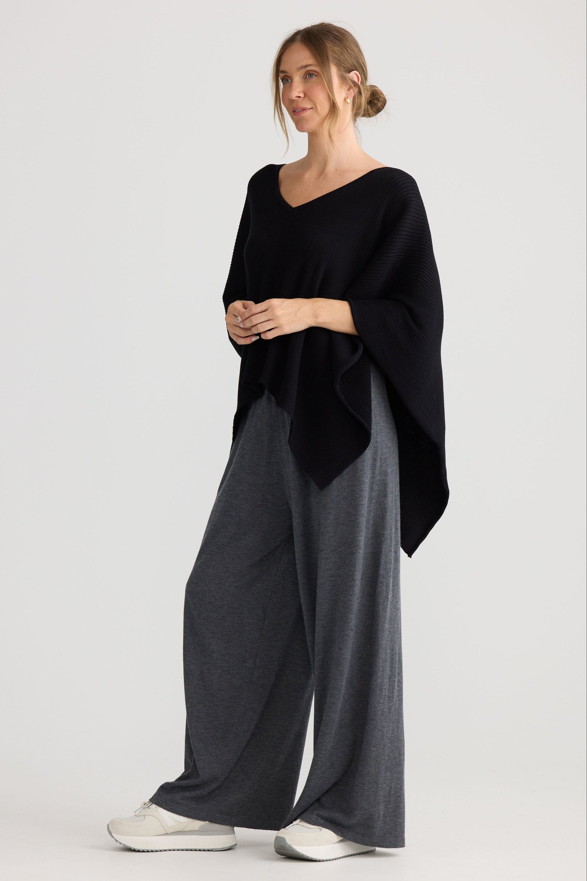 Model wearing Affirm Cape in black.