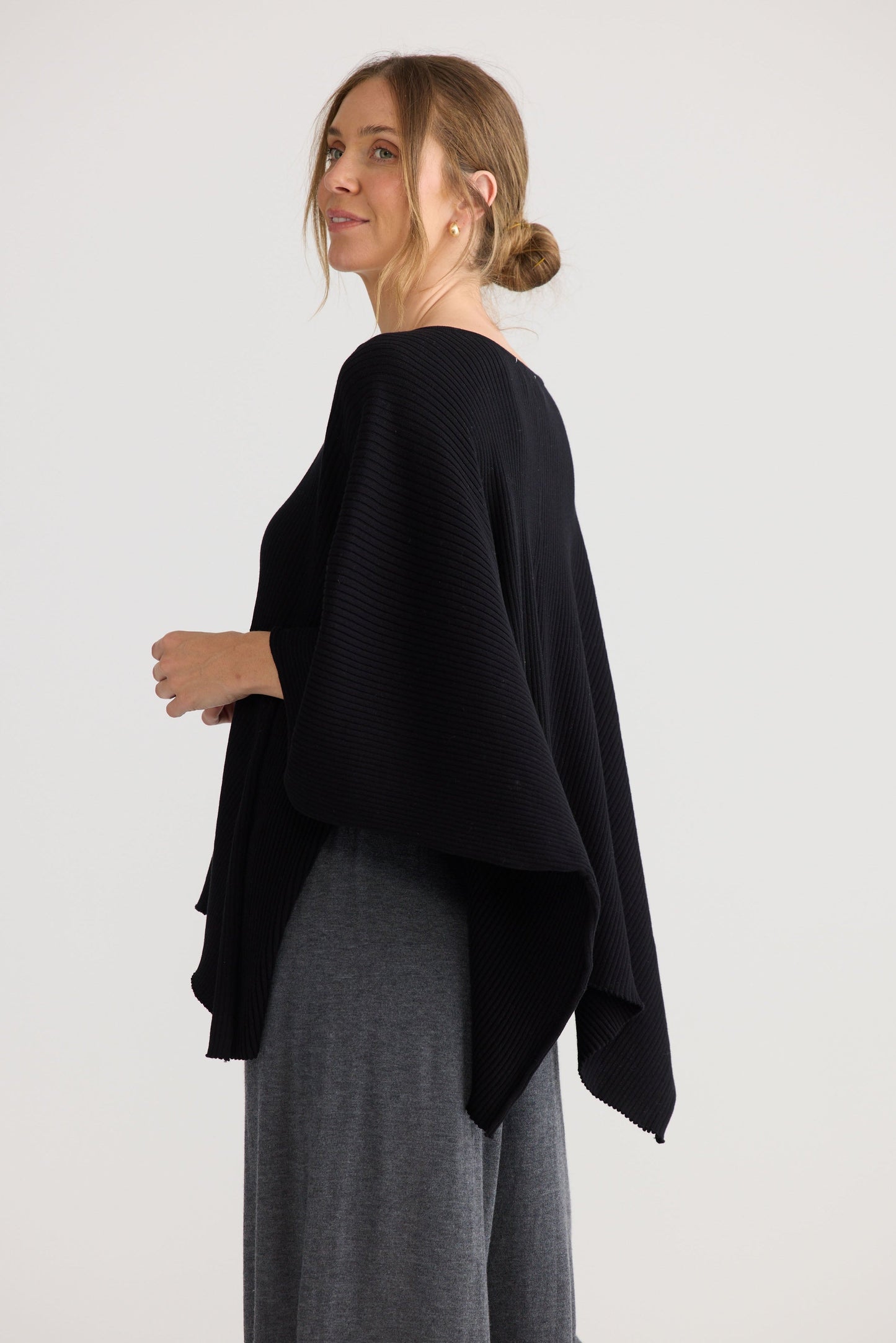 Affirm Cape in black, showing draped cape shape.