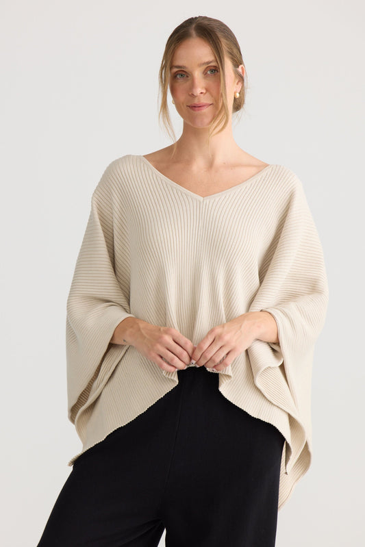 Affirm Cape in cream, showing draped cape shape.