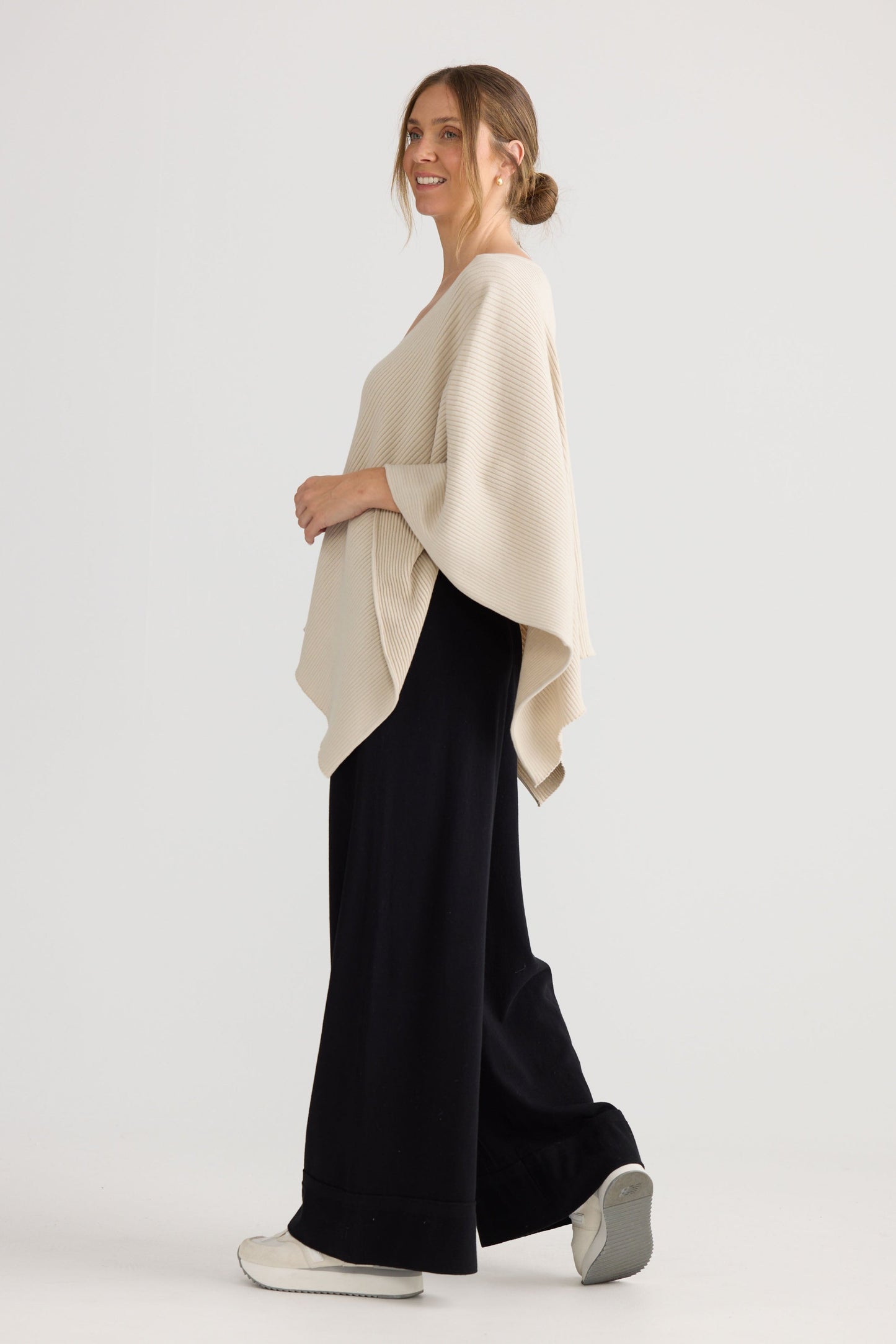 Model wearing Affirm Cape in cream.