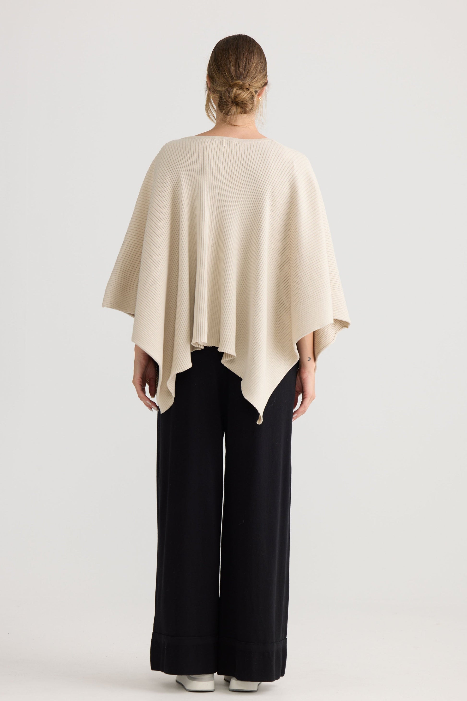 Affirm Cape in cream, styled with a relaxed outfit.