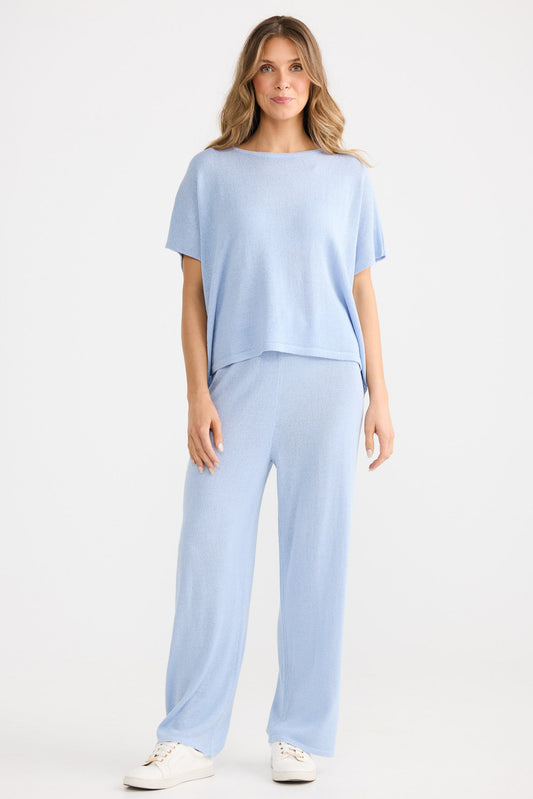 Woman wearing a light blue outfit on a white background