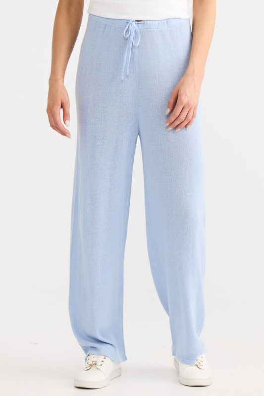 Light blue pants worn by a person on a white background