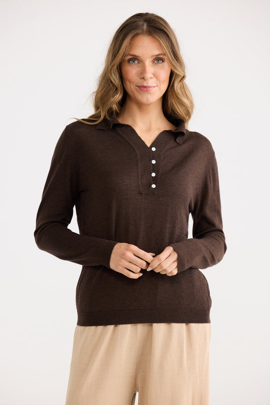 Woman wearing a brown long-sleeve shirt with buttons on a white background