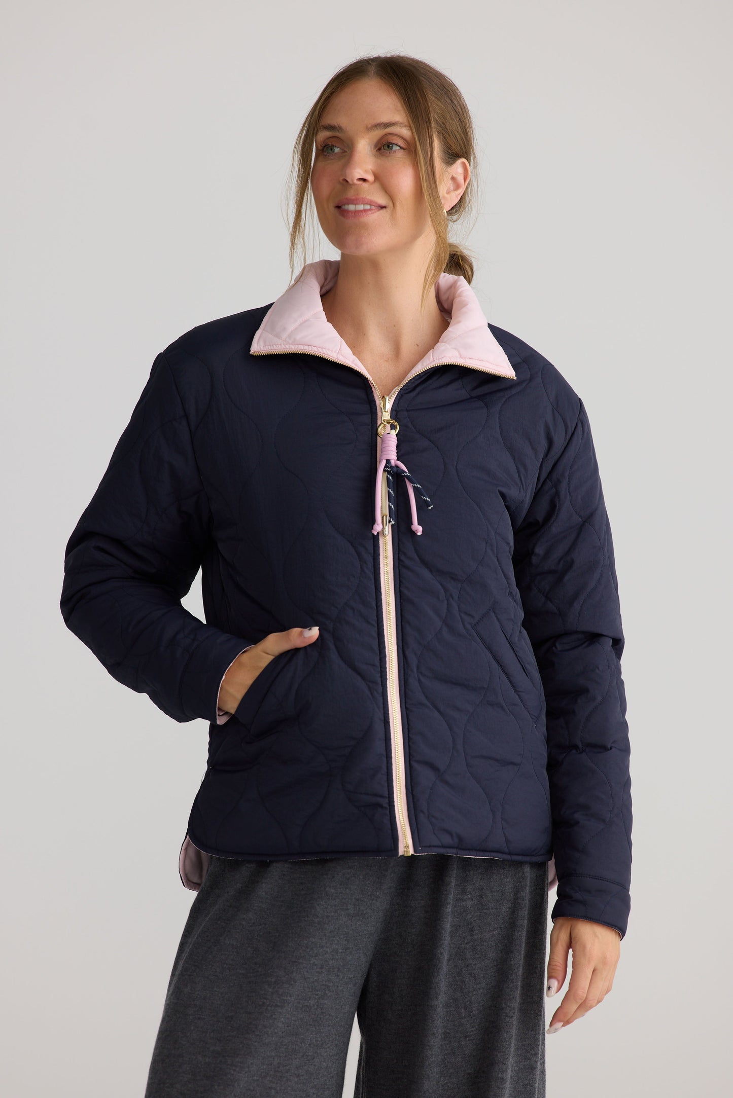 Ellis Puffer in navy with pink, shown in a styled product image.