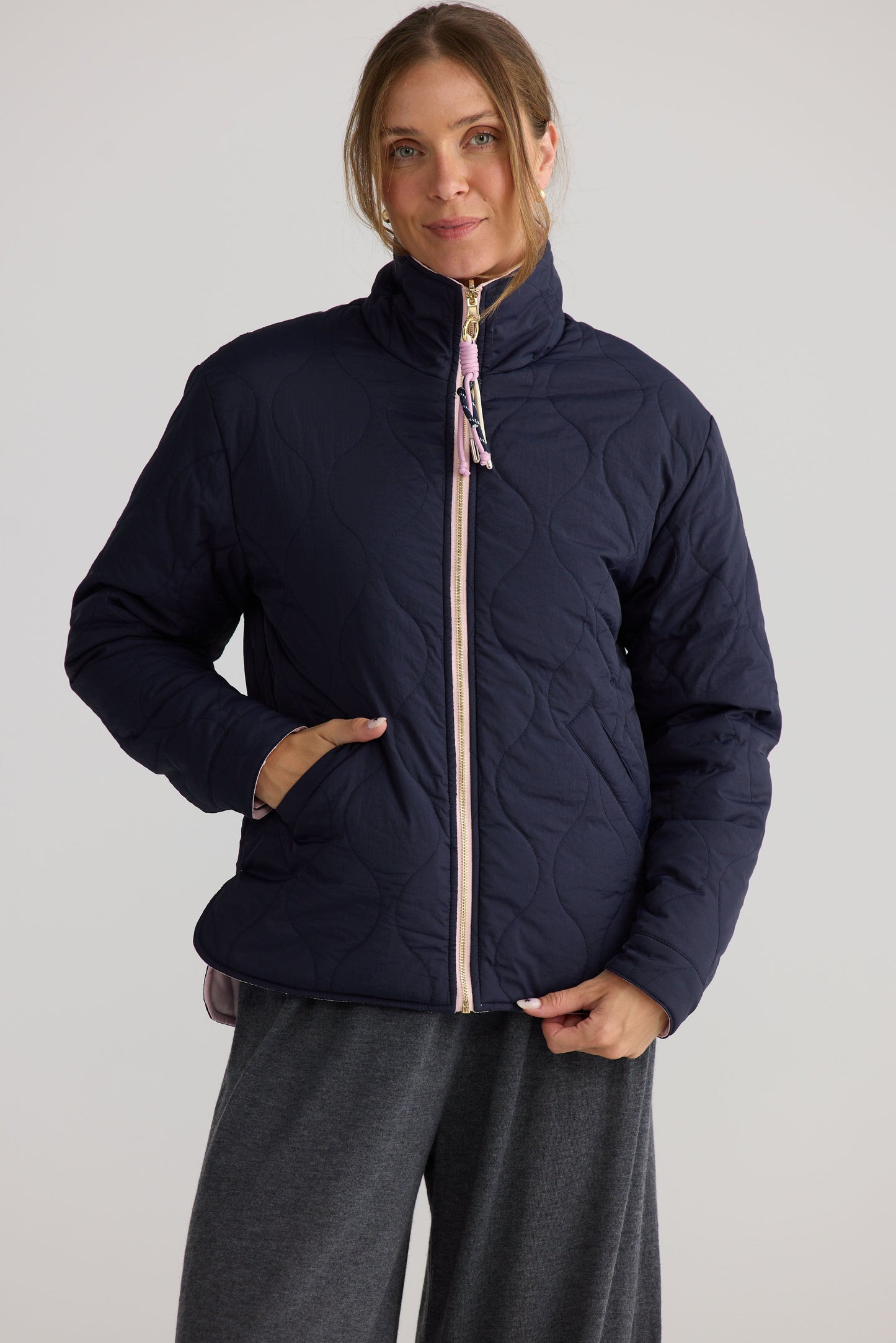 Model wearing Ellis Puffer in navy with pink.