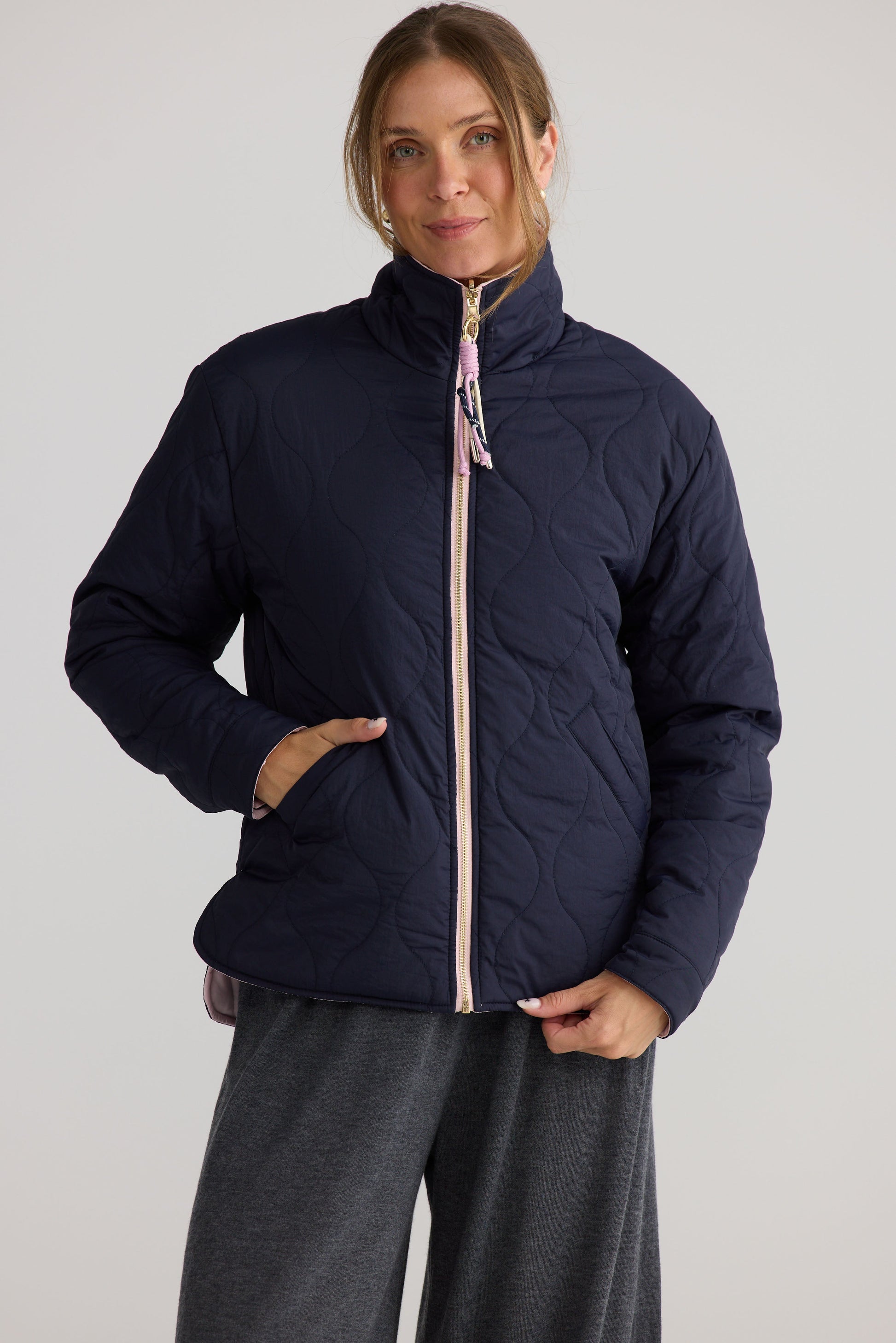 Model wearing Ellis Puffer in navy with pink.