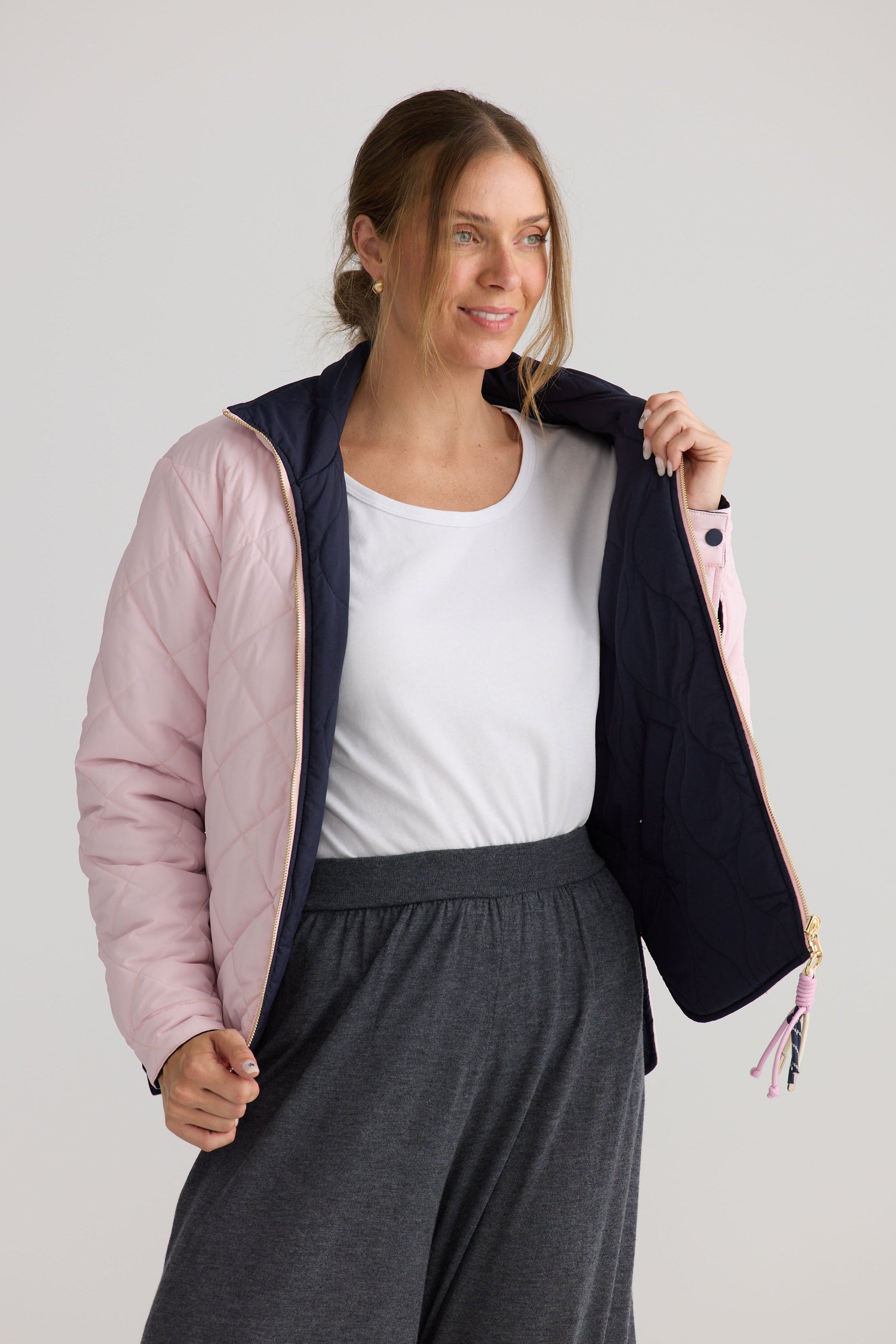 Model wearing Ellis Puffer in navy with pink, styled for everyday wear.