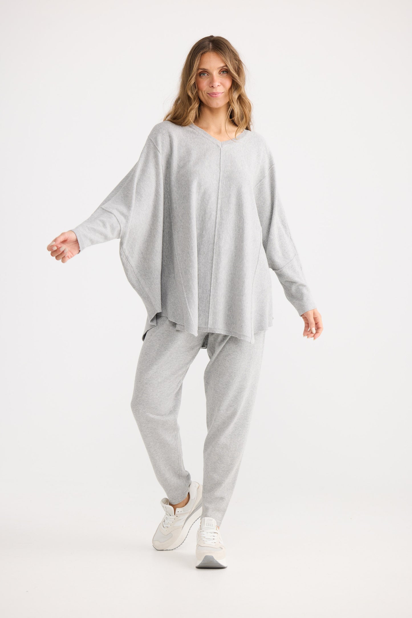 Woman wearing a gray outfit on a white background