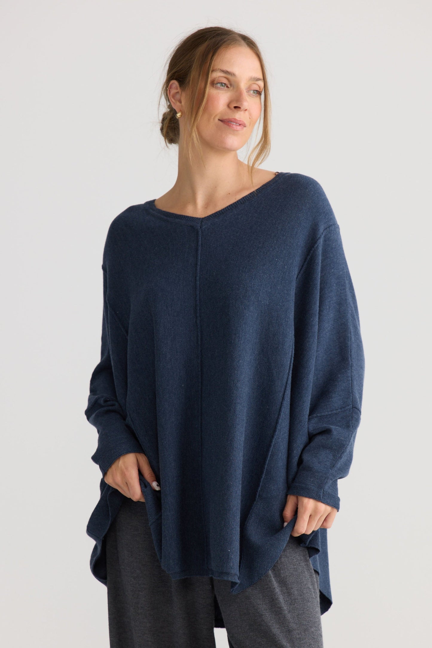 Model wearing Chill Top in navy, showing v-neckline.