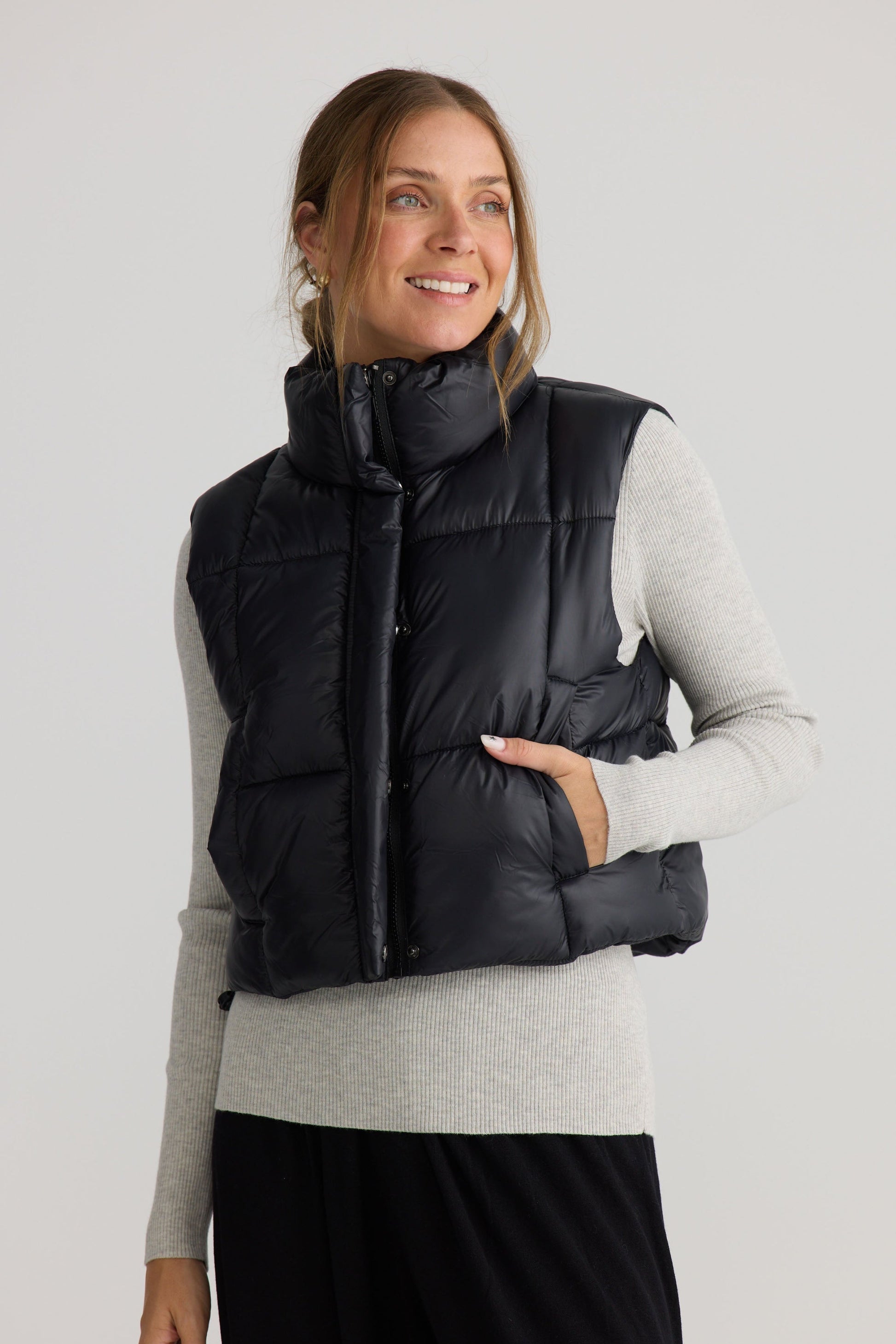 Model wearing Linden Puffer Vest in black, styled for everyday wear.