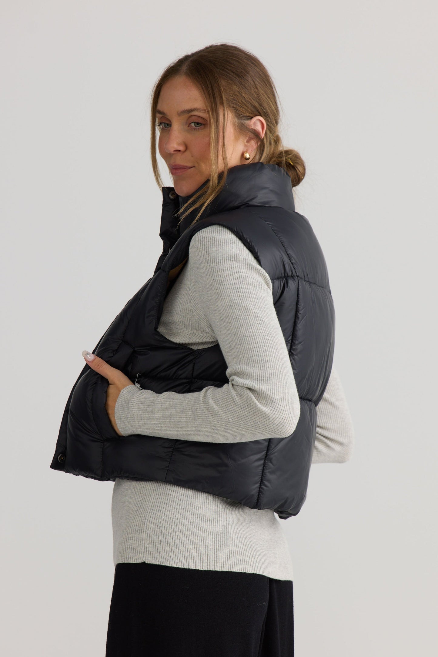 Linden Puffer Vest in black, shown on model.