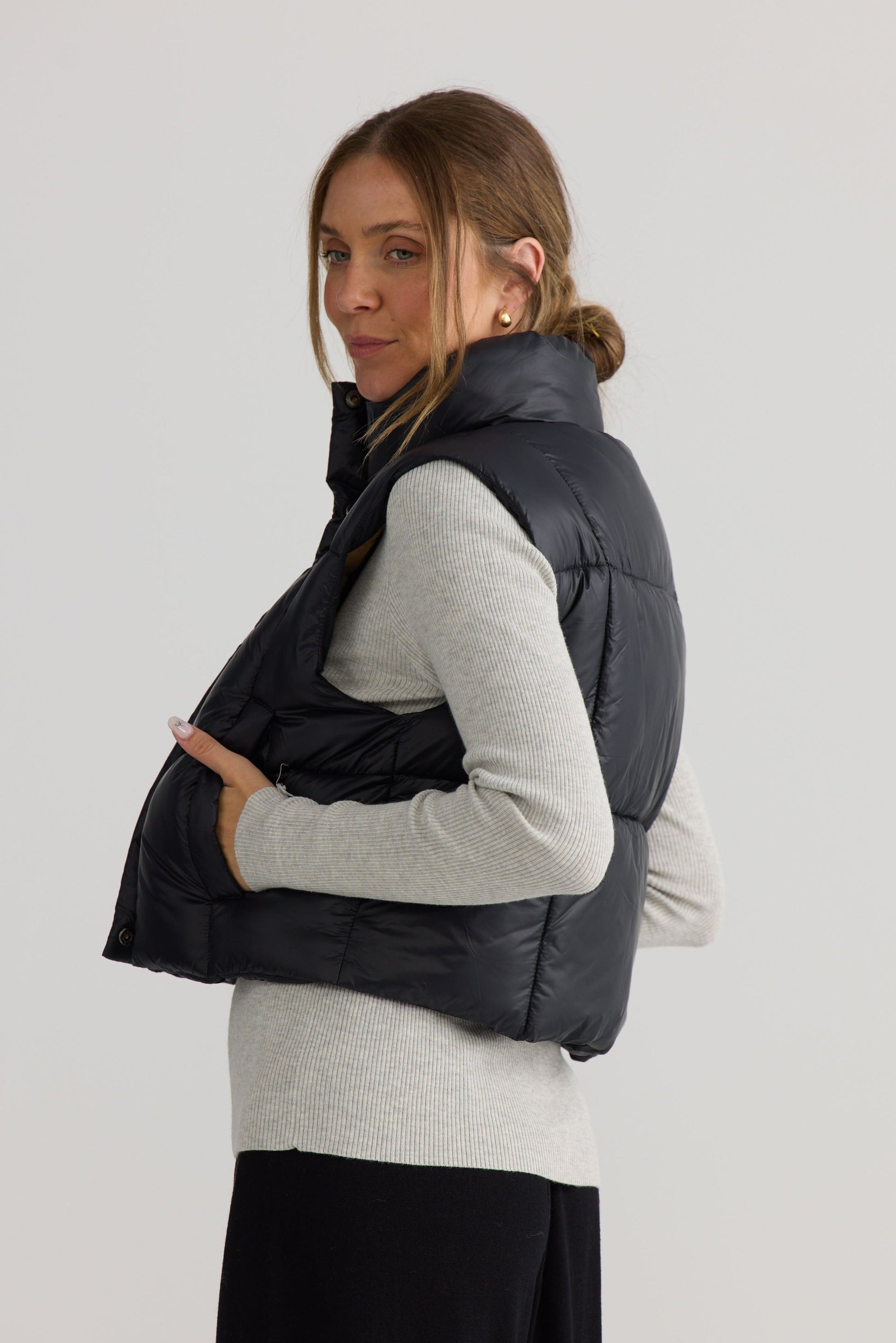 Linden Puffer Vest in black, shown on model.