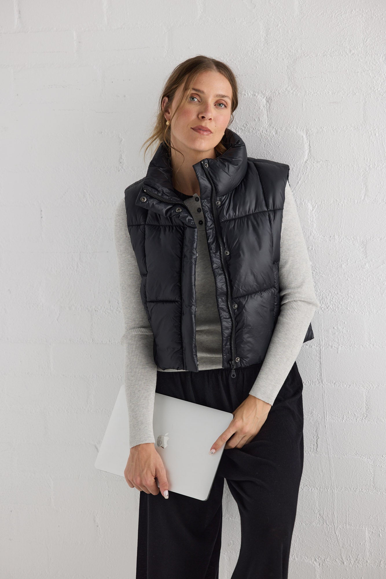 Campaign image of model wearing Linden Puffer Vest in black.