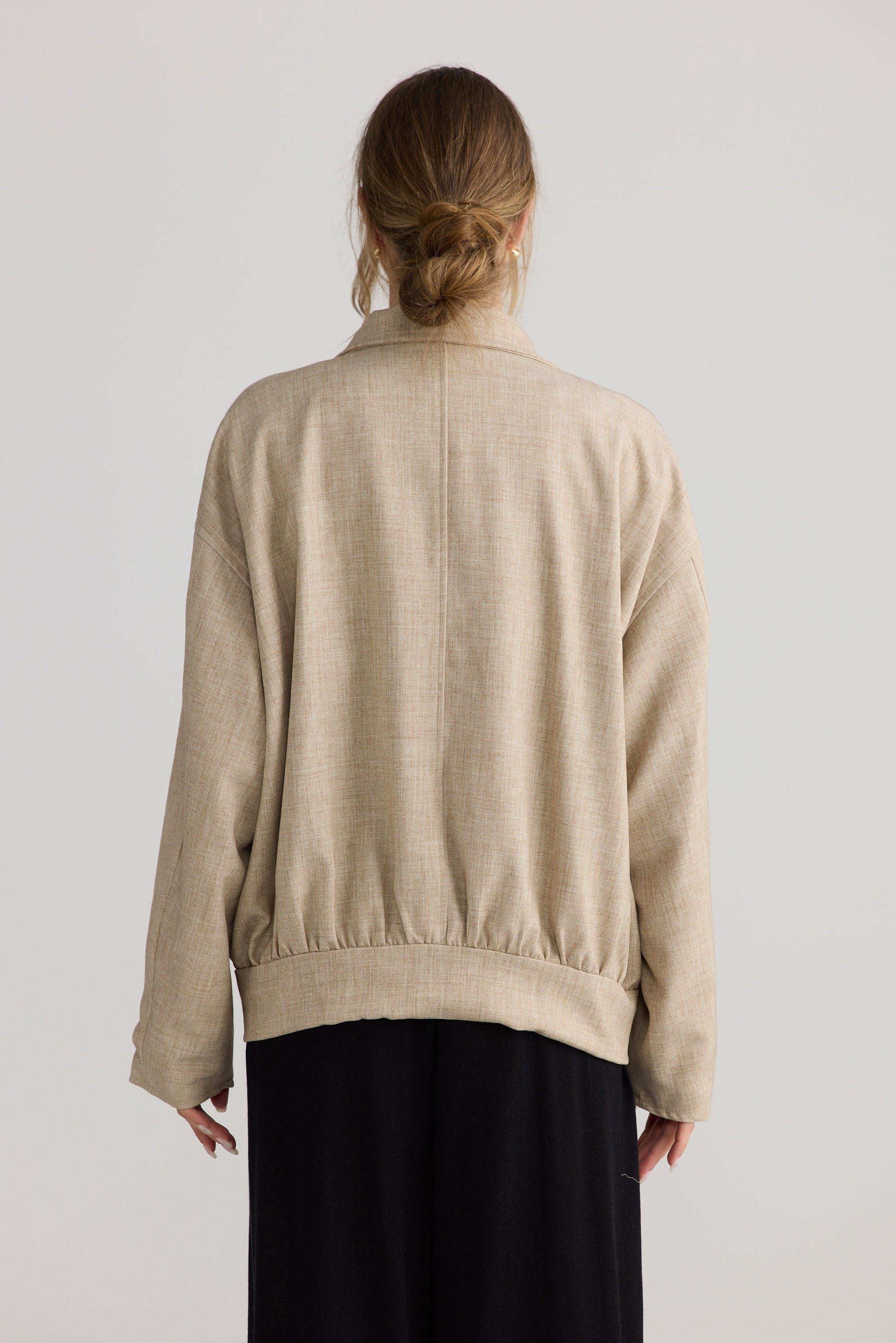 Model wearing Edie Jacket in stone, styled for everyday wear.