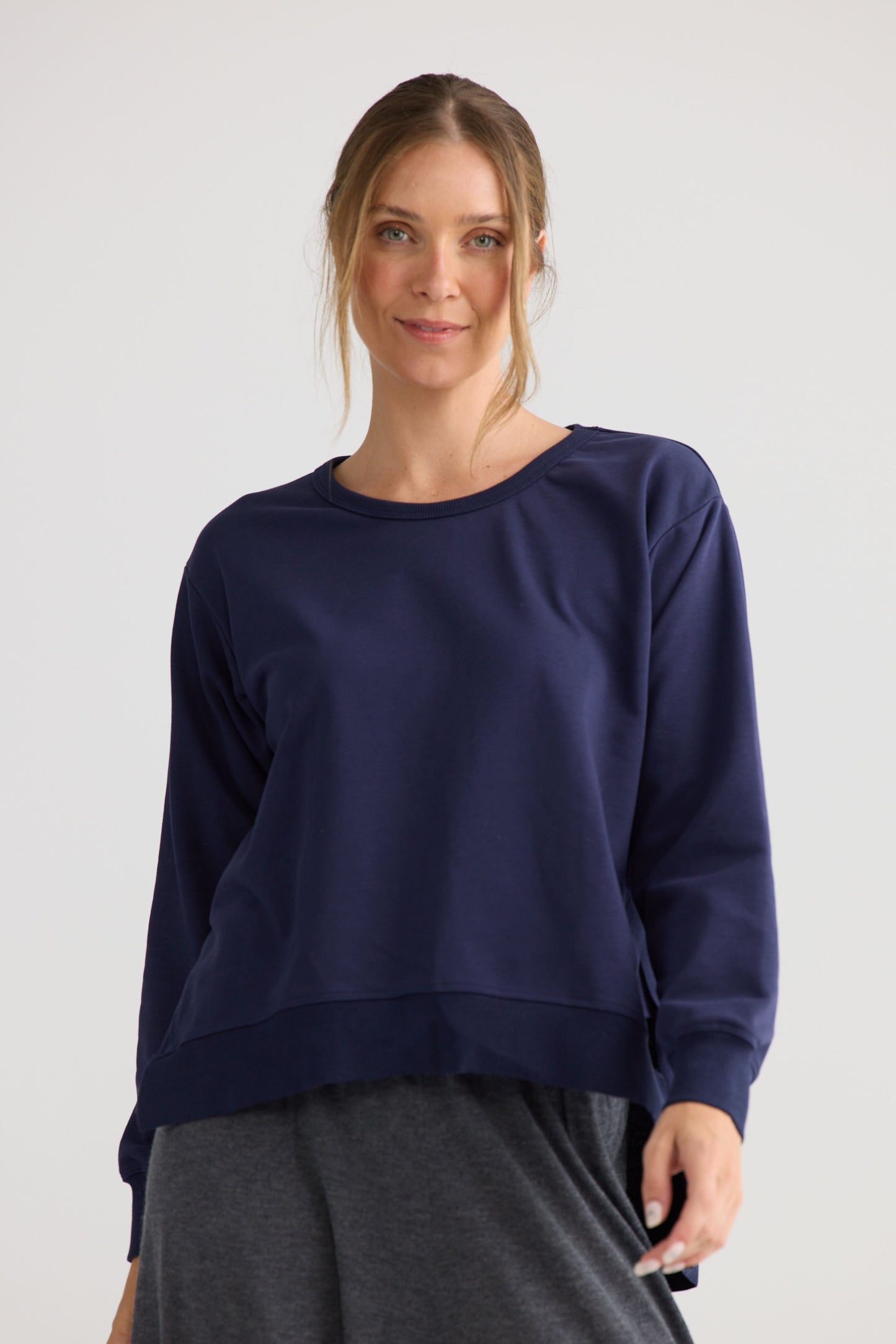 Model wearing Faye Lounge Jumper in navy.