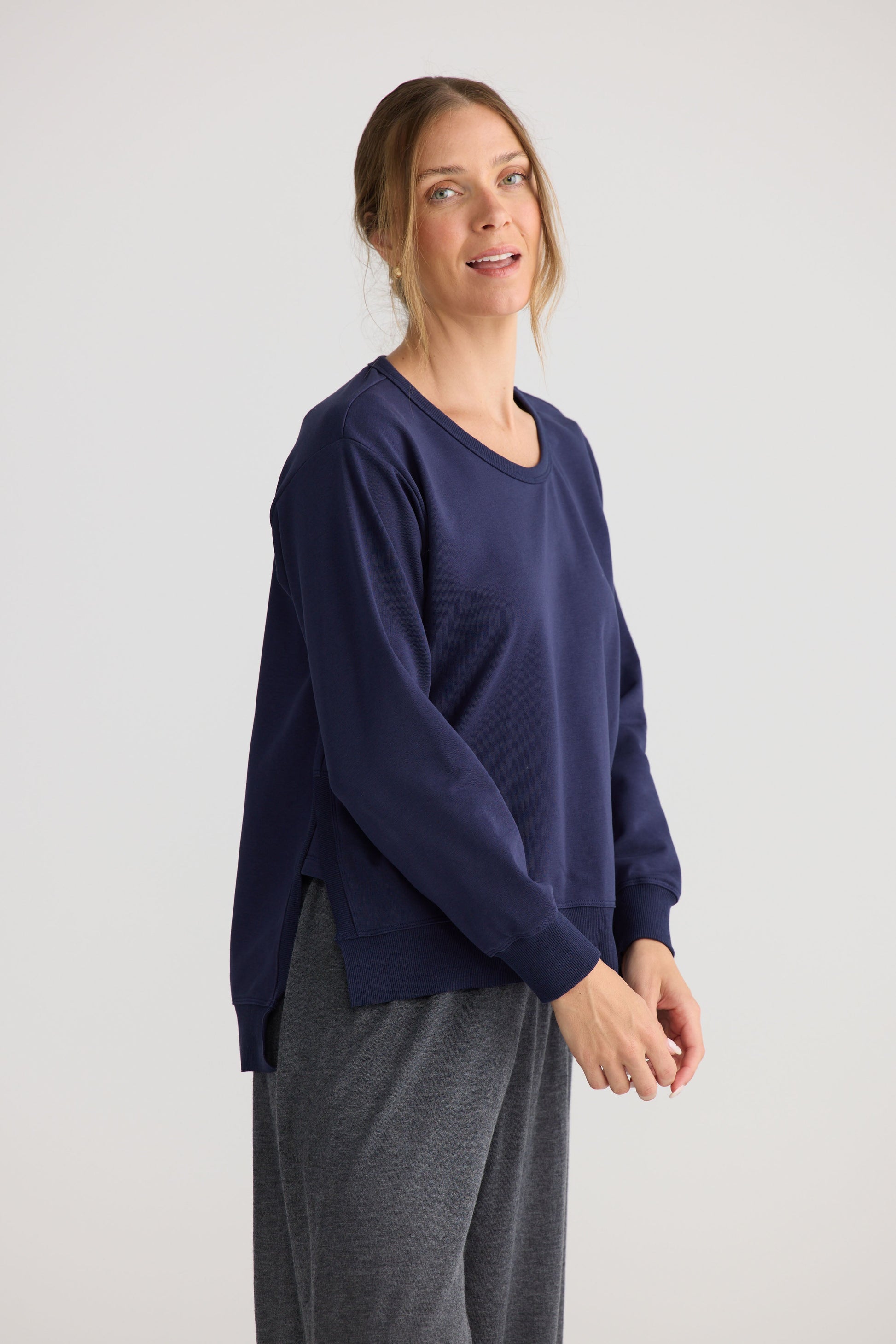 Model wearing Faye Lounge Jumper in navy, showing knit texture.