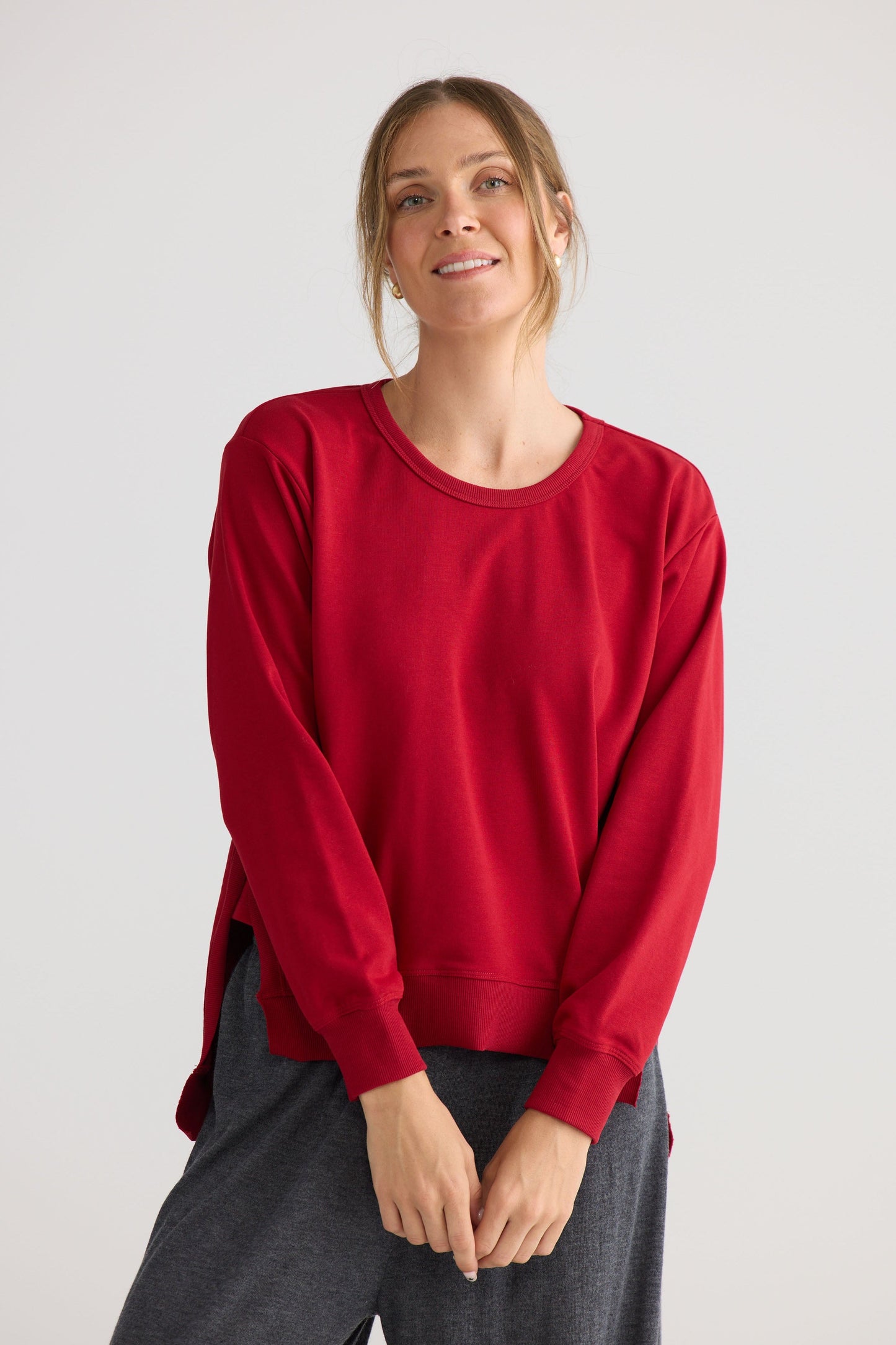 Faye Lounge Jumper in scarlet, styled with a relaxed outfit.
