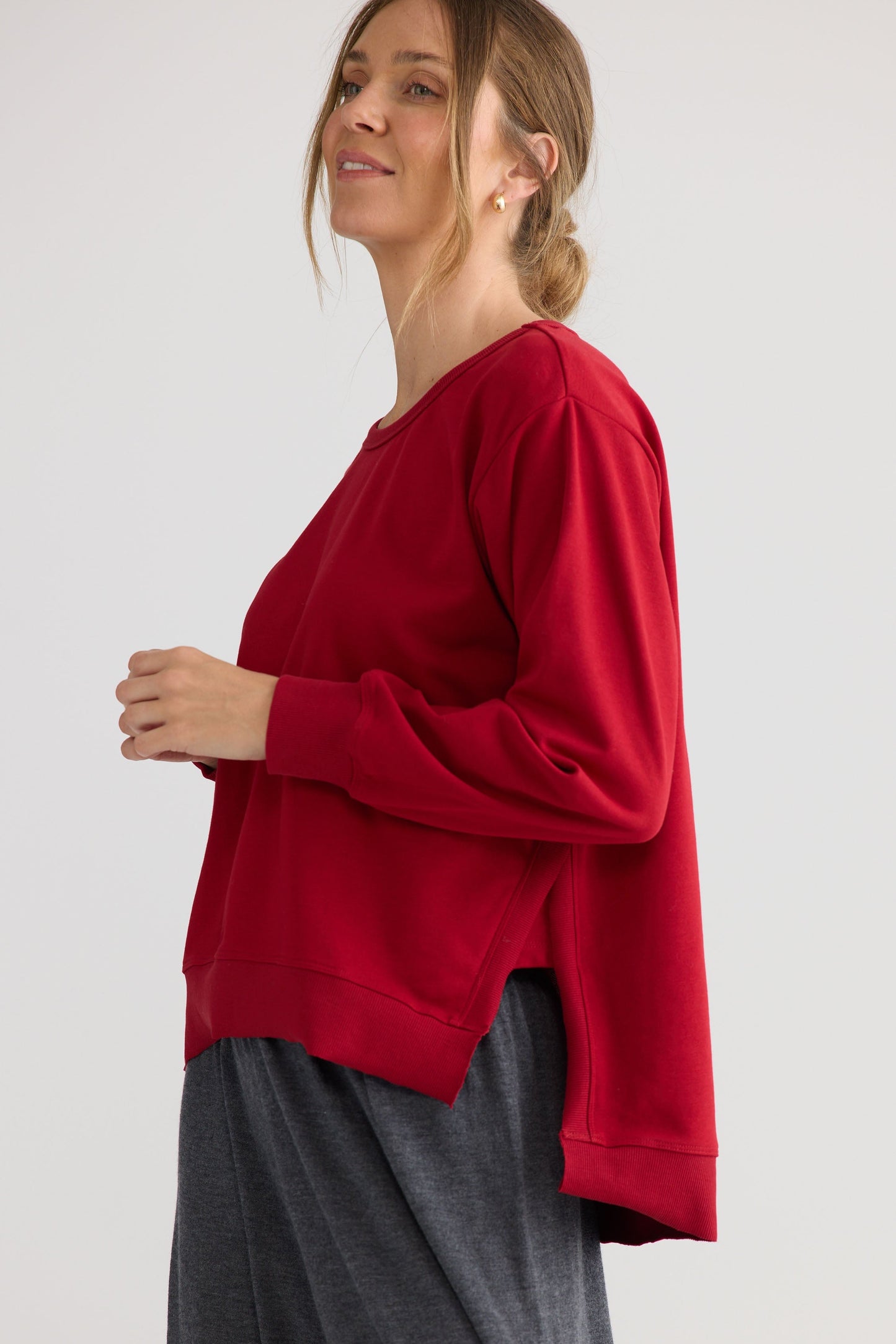 Model wearing Faye Lounge Jumper in scarlet, showing knit texture.
