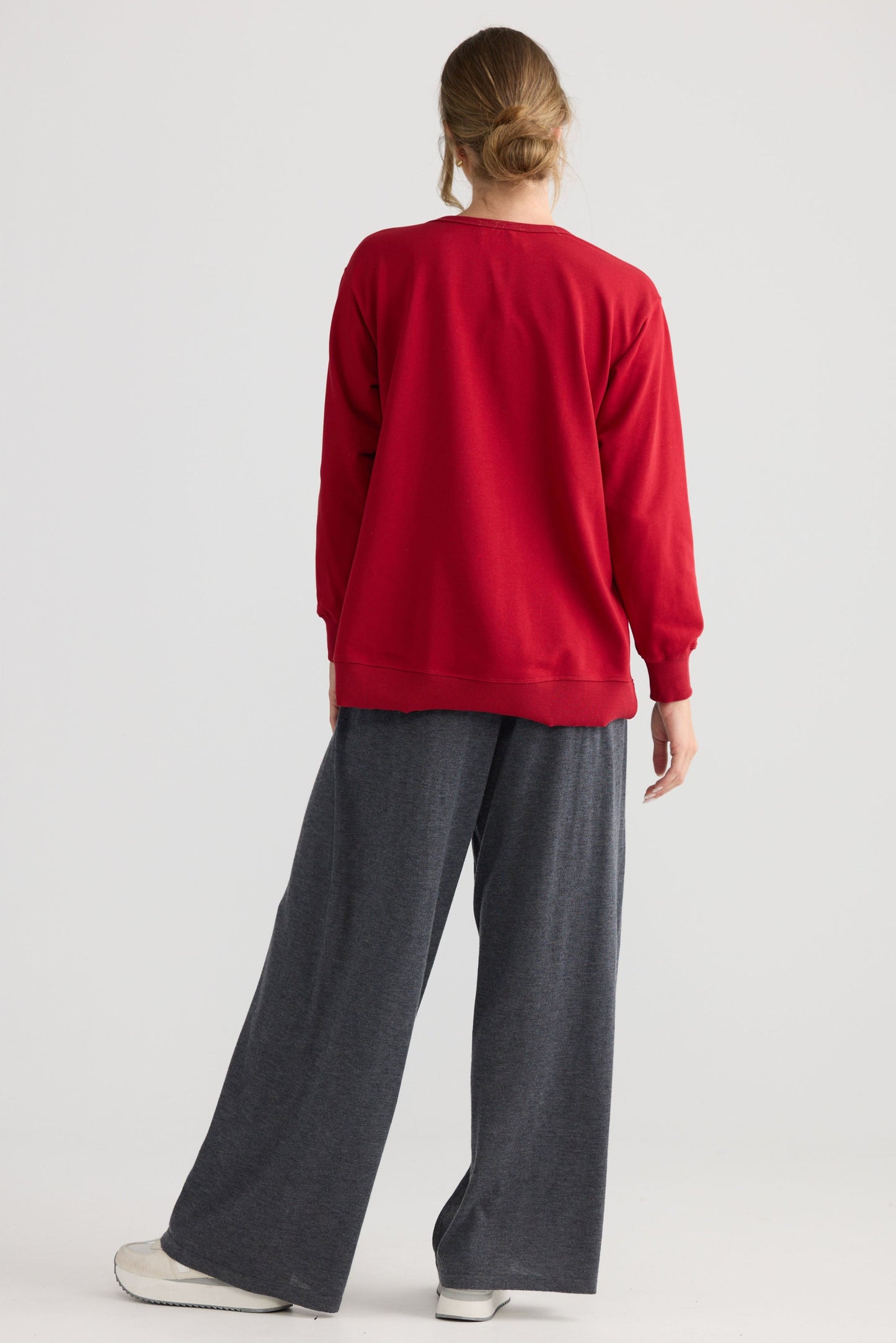 Model wearing Faye Lounge Jumper in scarlet.