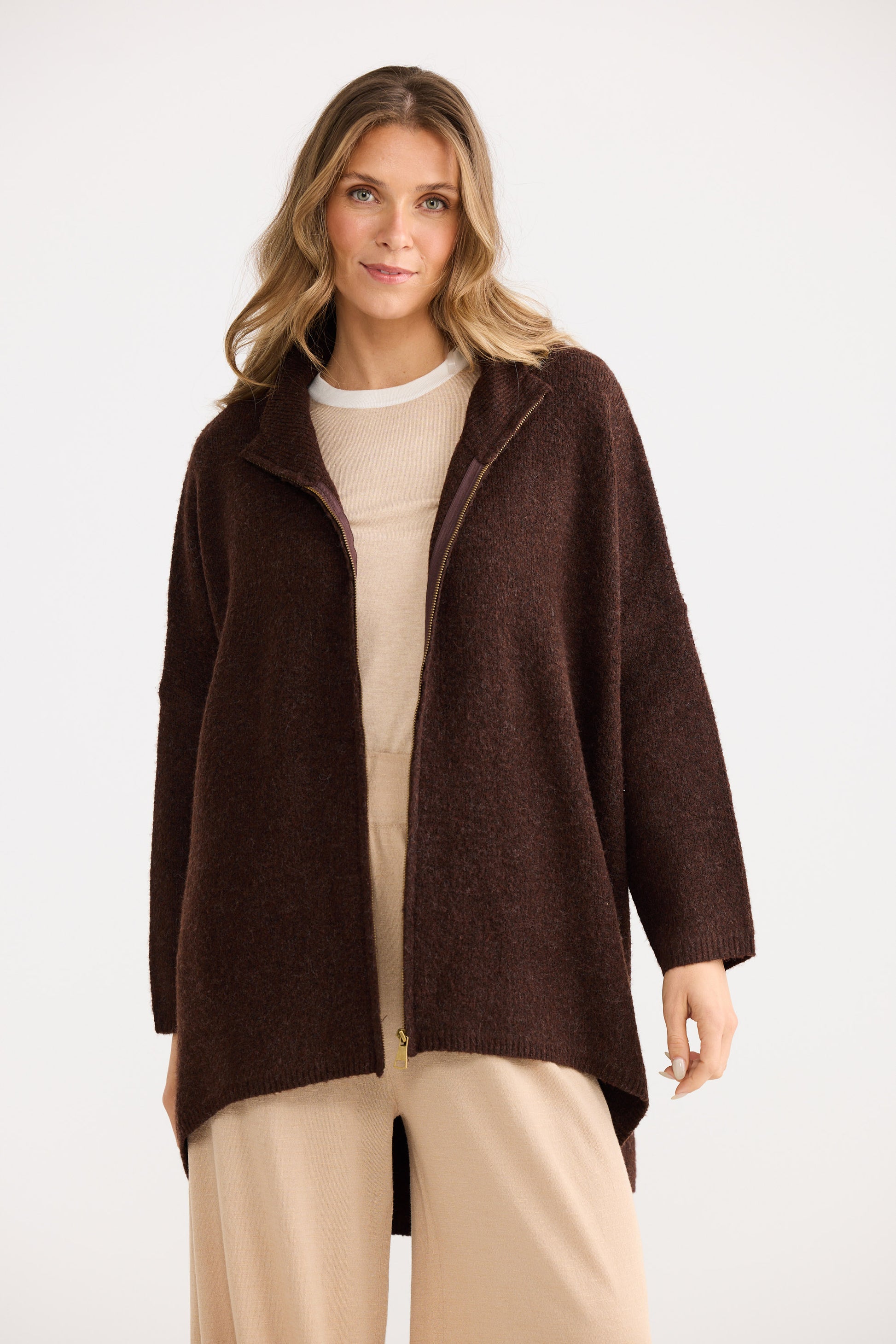 Woman wearing a brown coat on a white background