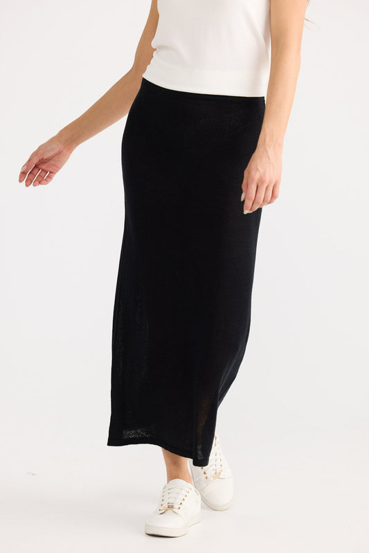 Person wearing a black skirt and white top on a white background