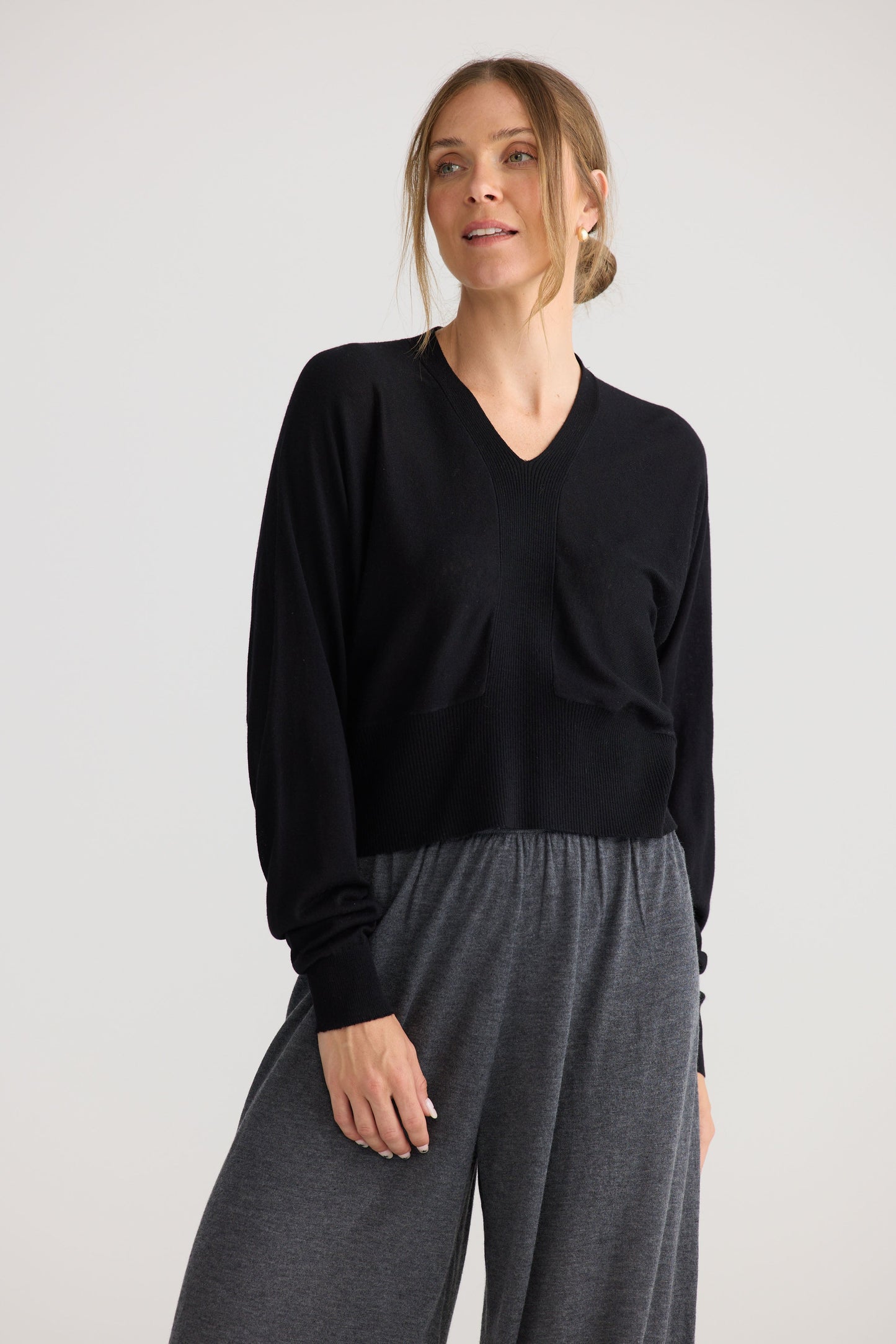 Model wearing Stillness Knit in black, showing knit texture.