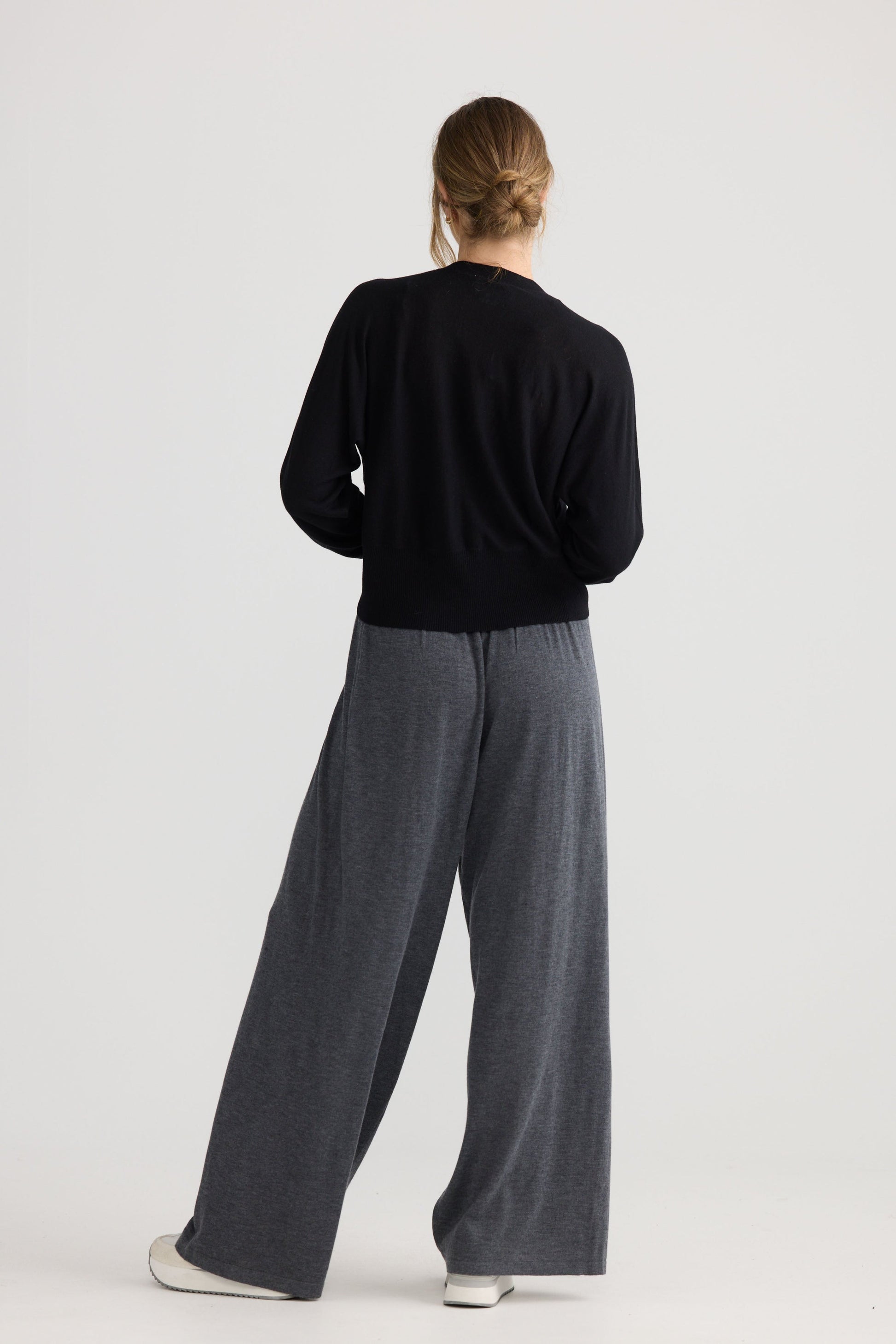 Model wearing Stillness Knit in black.
