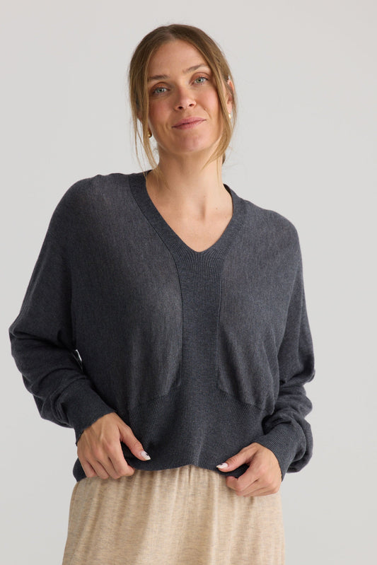 Model wearing Stillness Knit in charcoal.