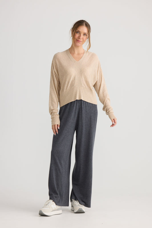 Model wearing Stillness Knit in oat, showing knit texture.
