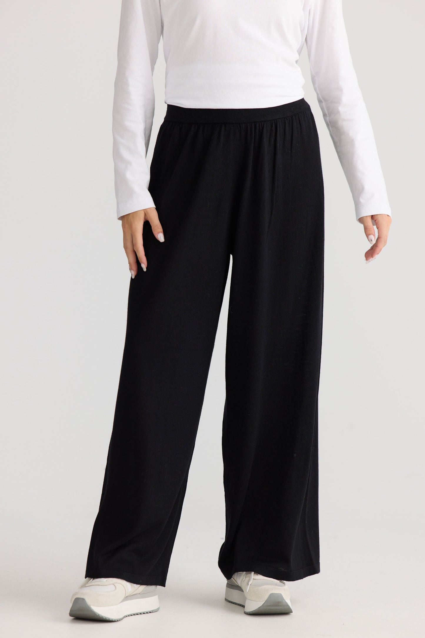 Model wearing Stillness Knit Pant in black, styled for everyday wear.