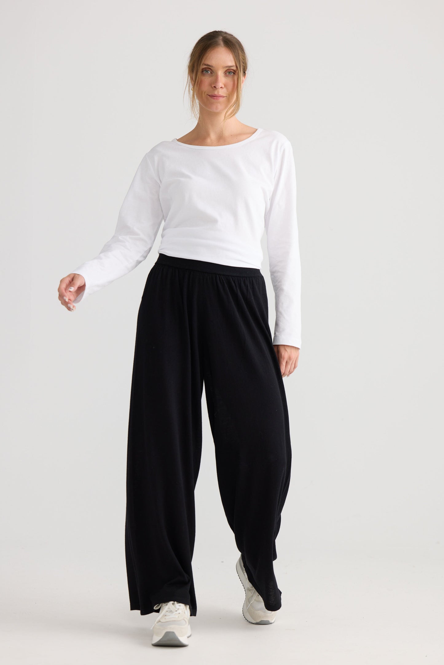 Model wearing Stillness Knit Pant in black.